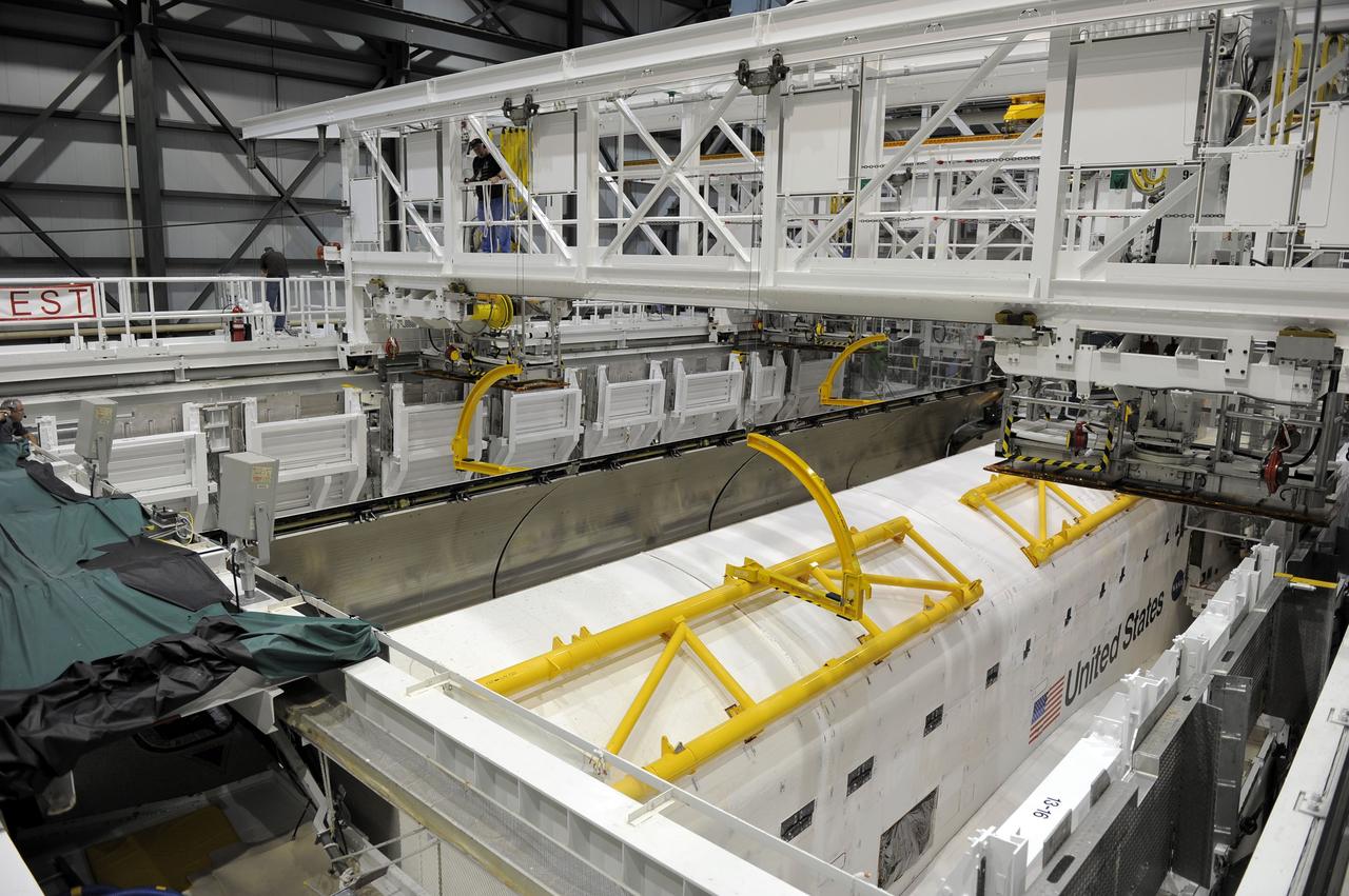 CAPE CANAVERAL, Fla. -- In Orbiter Processing Facility-2 at NASA’s Kennedy Space Center in Florida, technicians begin to open space shuttle Endeavour’s payload bay doors in order to retract an antenna. Space Shuttle Program transition and retirement work continues on Discovery and Endeavour in the orbiter processing facilities, while shuttle Atlantis is in temporary storage in high bay 4 of the Vehicle Assembly Building. Endeavour is being prepared for display at the California Science Center in Los Angeles. Photo credit: NASA/Kim Shiflett