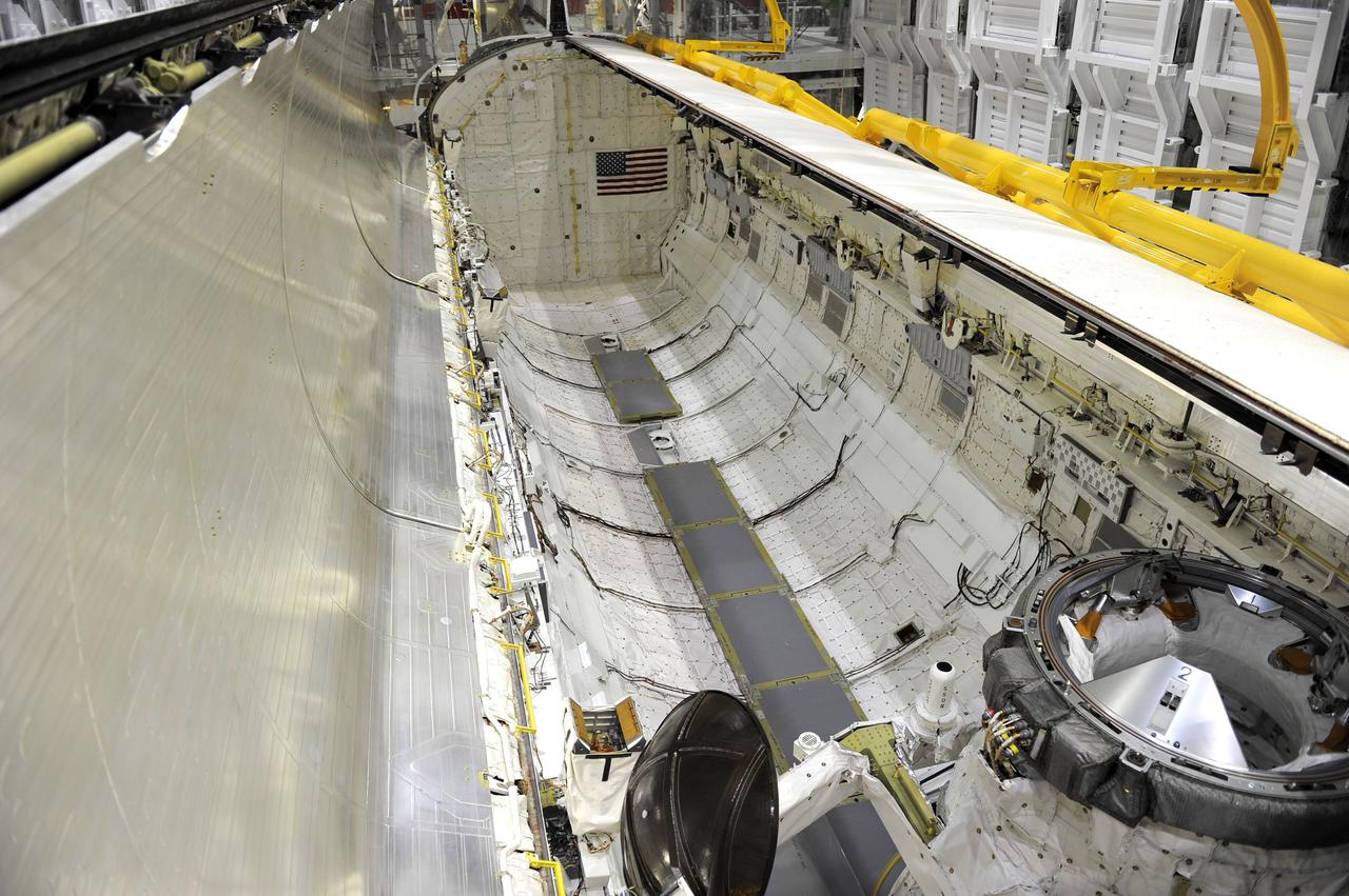 CAPE CANAVERAL, Fla. - In Orbiter Processing Facility-2 at NASA’s Kennedy Space Center in Florida, one of space shuttle Endeavour’s payload bay doors has been fully opened so that technicians can retract an antenna. Space Shuttle Program transition and retirement work continues on Discovery and Endeavour in the orbiter processing facilities, while shuttle Atlantis is in temporary storage in high bay 4 of the Vehicle Assembly Building. Endeavour is being prepared for display at the California Science Center in Los Angeles. Photo credit: NASA/Kim Shiflett