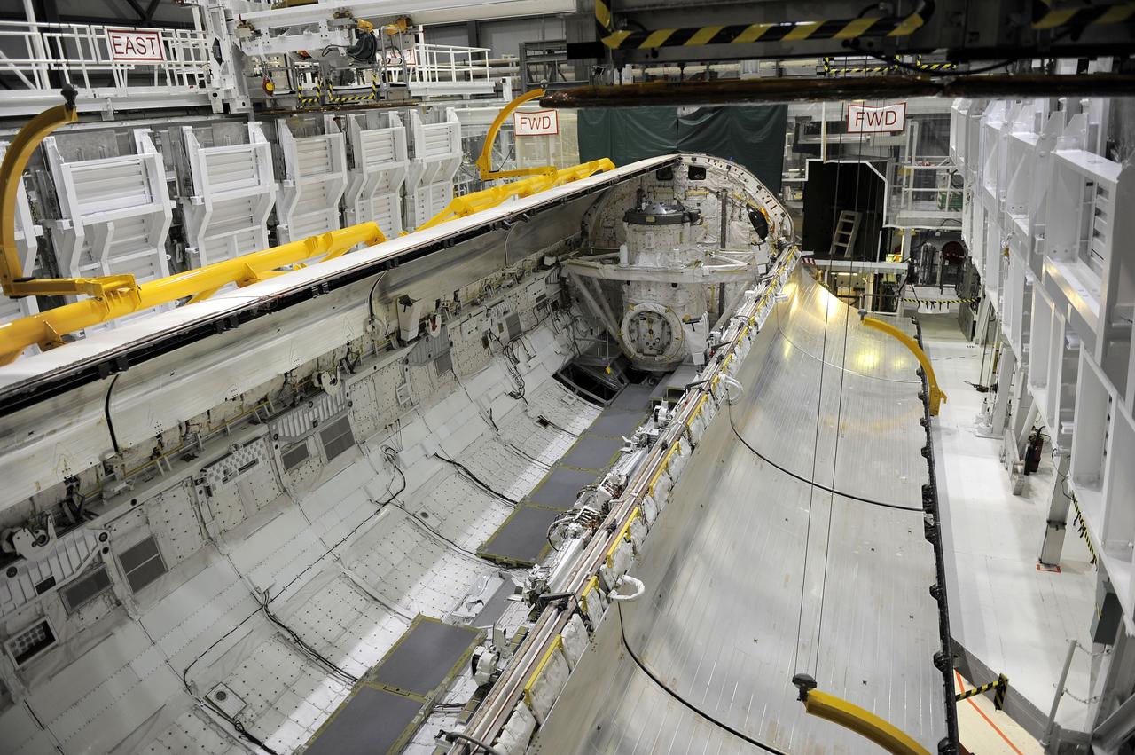 CAPE CANAVERAL, Fla. - In Orbiter Processing Facility-2 at NASA’s Kennedy Space Center in Florida, one of space shuttle Endeavour’s payload bay doors has been fully opened so that an antenna can be retracted. Space Shuttle Program transition and retirement work continues on Discovery and Endeavour in the orbiter processing facilities, while shuttle Atlantis is in temporary storage in high bay 4 of the Vehicle Assembly Building. Endeavour is being prepared for display at the California Science Center in Los Angeles. Photo credit: NASA/Kim Shiflett
