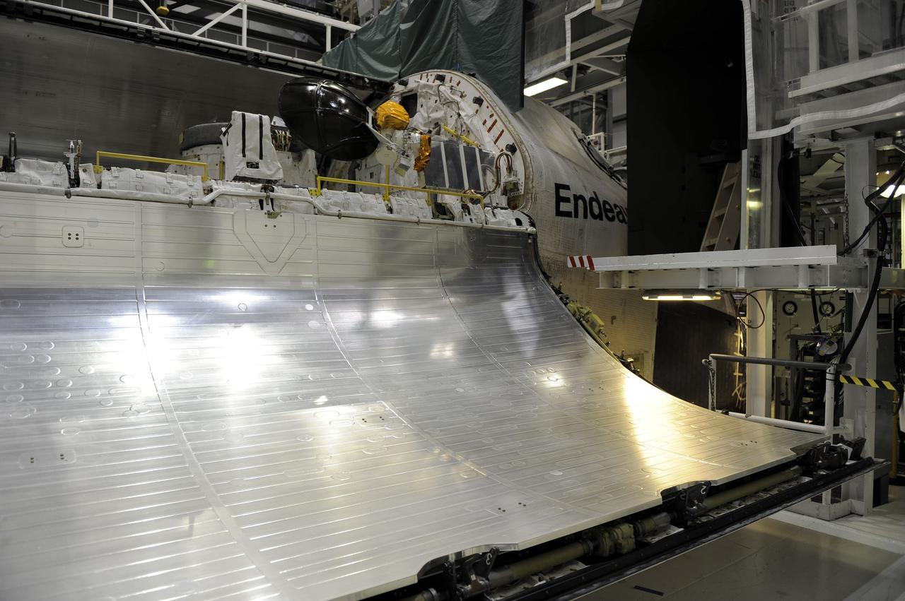 CAPE CANAVERAL, Fla. – In Orbiter Processing Facility-2 at NASA’s Kennedy Space Center in Florida, one of space shuttle Endeavour’s payload bay doors has been fully opened so that an antenna can be retracted. Space Shuttle Program transition and retirement work continues on Discovery and Endeavour in the orbiter processing facilities, while shuttle Atlantis is in temporary storage in high bay 4 of the Vehicle Assembly Building. Endeavour is being prepared for display at the California Science Center in Los Angeles. Photo credit: NASA/Kim Shiflett