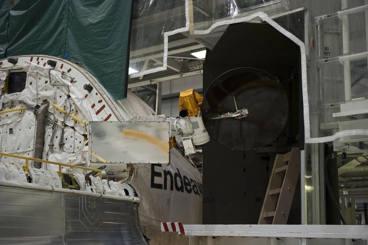 CAPE CANAVERAL, Fla. -- In Orbiter Processing Facility-2 at NASA’s Kennedy Space Center in Florida, one of space shuttle Endeavour’s payload bay doors has been fully opened and an antenna has been retracted. Space Shuttle Program transition and retirement work continues on Discovery and Endeavour in the orbiter processing facilities, while shuttle Atlantis is in temporary storage in high bay 4 of the Vehicle Assembly Building. Endeavour is being prepared for display at the California Science Center in Los Angeles. Photo credit: NASA/Kim Shiflett