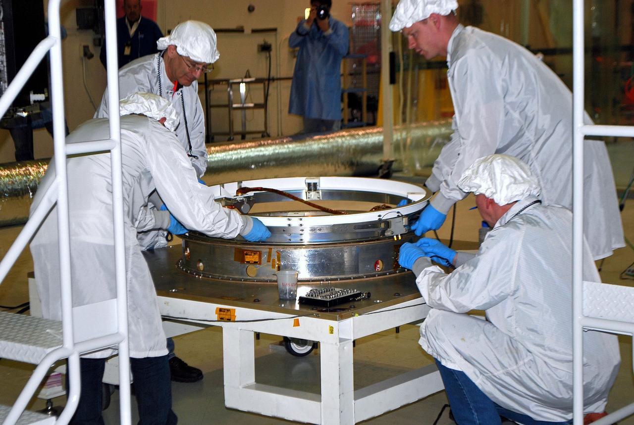 VANDENBERG AIR FORCE BASE, Calif. – In processing facility 1555 at Vandenberg Air Force Base in California, spacecraft technicians position a Pegasus fairing separation ring on the workstand for NASA's Nuclear Spectroscopic Telescope Array (NuSTAR). A Pegasus XL rocket is being prepared to launch NuSTAR into space in March. Once processing of the rocket and spacecraft are completed at Vandenberg, they will be flown on the Orbital Sciences’ L-1011 carrier aircraft to the Ronald Reagan Ballistic Missile Defense Test Site at the Pacific Ocean’s Kwajalein Atoll for launch. NuSTAR, a high-energy x-ray telescope, will conduct a census for black holes, map radioactive material in young supernovae remnants, and study the origins of cosmic rays and the extreme physics around collapsed stars. For more information, visit http://www.nasa.gov/nustar. Photo credit: NASA/Randy Beaudoin, VAFB