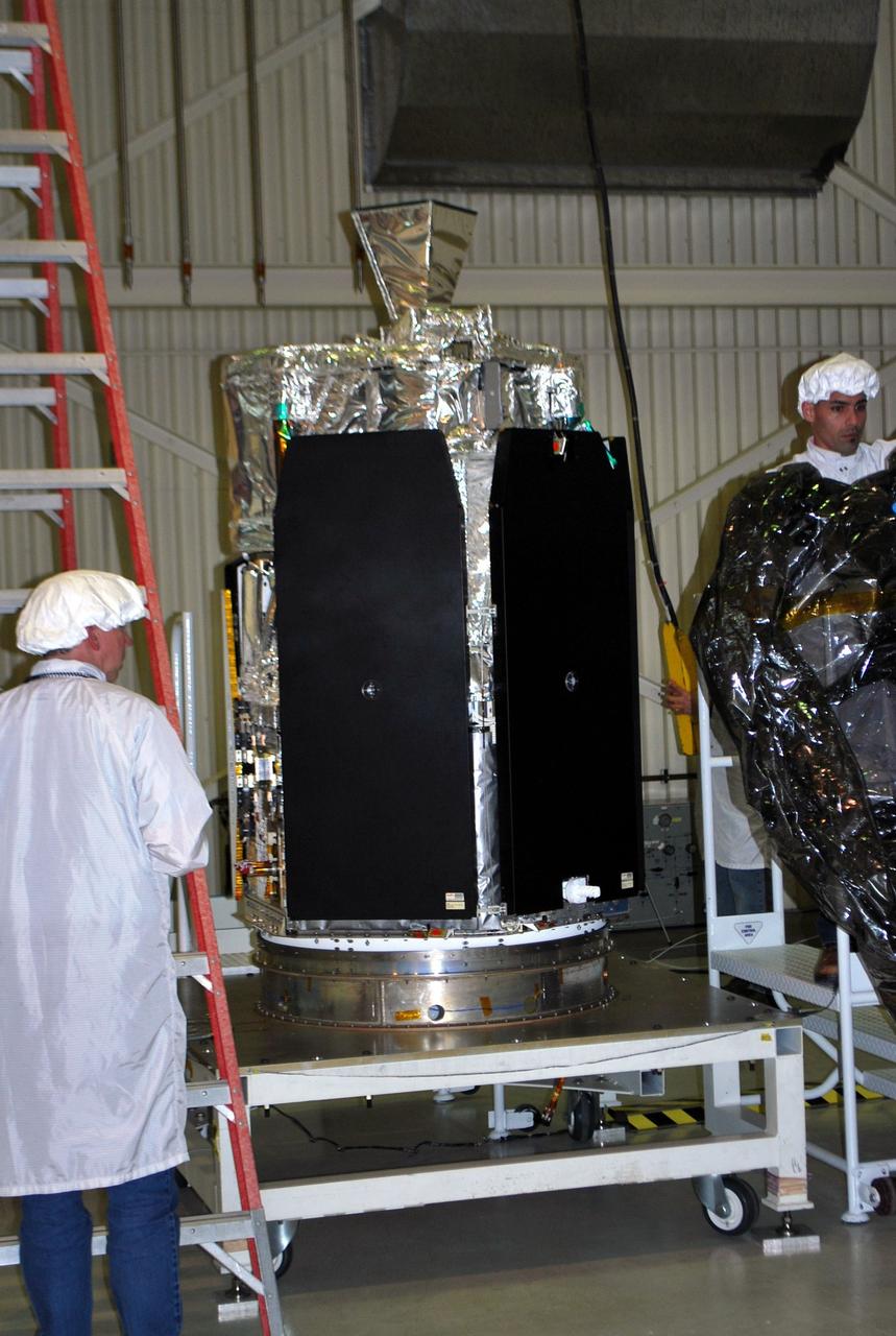VANDENBERG AIR FORCE BASE, Calif. – In processing facility 1555 at Vandenberg Air Force Base in California, NASA's Nuclear Spectroscopic Telescope Array (NuSTAR) is secured to a Pegasus fairing separation ring, positioned on its workstand. A Pegasus XL rocket is being prepared to launch NuSTAR into space in March. Once processing of the rocket and spacecraft are completed at Vandenberg, they will be flown on the Orbital Sciences’ L-1011 carrier aircraft to the Ronald Reagan Ballistic Missile Defense Test Site at the Pacific Ocean’s Kwajalein Atoll for launch. NuSTAR, a high-energy x-ray telescope, will conduct a census for black holes, map radioactive material in young supernovae remnants, and study the origins of cosmic rays and the extreme physics around collapsed stars. For more information, visit http://www.nasa.gov/nustar. Photo credit: NASA/Randy Beaudoin, VAFB
