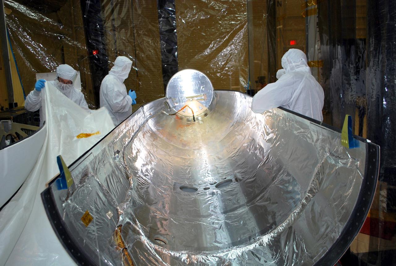 VANDENBERG AIR FORCE BASE, Calif. – In an environmental enclosure in processing facility 1555 at Vandenberg Air Force Base in California, cleaning and inspection of half of a Pegasus payload fairing for NASA's Nuclear Spectroscopic Telescope Array (NuSTAR) mission is under way.    The fairing will protect the spacecraft from the heat and aerodynamic pressure generated during ascent to orbit aboard an Orbital Sciences Pegasus XL rocket in March. Once processing of the rocket and spacecraft are completed at Vandenberg, they will be flown aboard an L-1011 carrier aircraft to the Ronald Reagan Ballistic Missile Defense Test Site on the Pacific Ocean’s Kwajalein Atoll for launch. NuSTAR, a high-energy x-ray telescope, will conduct a census for black holes, map radioactive material in young supernovae remnants, and study the origins of cosmic rays and the extreme physics around collapsed stars. For more information, visit http://www.nasa.gov/nustar.  Photo credit: NASA/Randy Beaudoin, VAFB