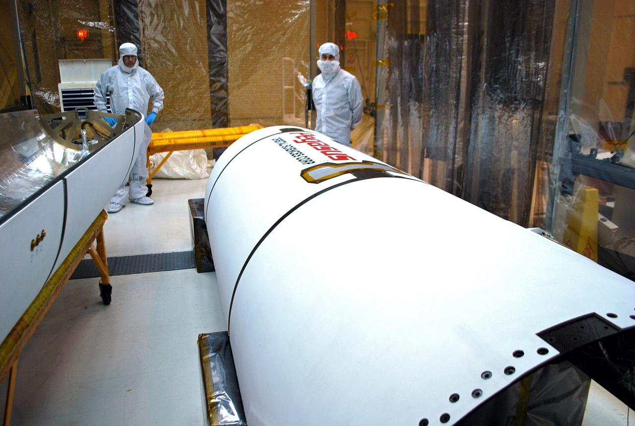 VANDENBERG AIR FORCE BASE, Calif. – In an environmental enclosure in processing facility 1555 at Vandenberg Air Force Base in California, twin segments of a Pegasus payload fairing for NASA's Nuclear Spectroscopic Telescope Array (NuSTAR) mission are cleaned and inspected before the spacecraft is encapsulated. The fairing will protect the spacecraft from the heat and aerodynamic pressure generated during ascent to orbit aboard an Orbital Sciences Pegasus XL rocket in March. Once processing of the rocket and spacecraft are completed at Vandenberg, they will be flown aboard an L-1011 carrier aircraft to the Ronald Reagan Ballistic Missile Defense Test Site on the Pacific Ocean’s Kwajalein Atoll for launch. NuSTAR, a high-energy x-ray telescope, will conduct a census for black holes, map radioactive material in young supernovae remnants, and study the origins of cosmic rays and the extreme physics around collapsed stars. For more information, visit http://www.nasa.gov/nustar. Photo credit: NASA/Randy Beaudoin, VAFB