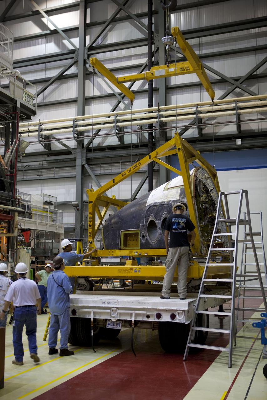 CAPE CANAVERAL, Fla. – In Orbiter Processing Facility-2 at NASA’s Kennedy Space Center in Florida, technicians prepare to lift the forward reaction control system (FRCS) for installation on space shuttle Endeavour. The work is part of the Space Shuttle Program transition and retirement processing of Endeavour. The FRCS helped maneuver a shuttle while it was in orbit. The FRCS was removed from Endeavour and sent to White Sands Test Facility in N.M. to be cleaned of its toxic propellants. Endeavour is being prepared for display at the California Science Center in Los Angeles. Photo credit: NASA/Dimitri Gerondidakis