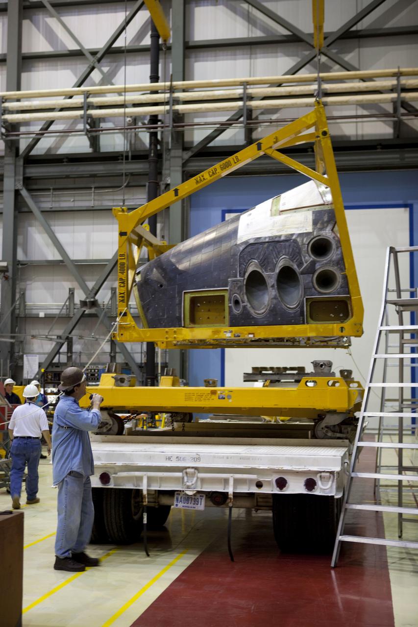 CAPE CANAVERAL, Fla. – In Orbiter Processing Facility-2 at NASA’s Kennedy Space Center in Florida, a technician monitors the progress as a large crane lifts the forward reaction control system (FRCS) for installation on space shuttle Endeavour. The work is part of the Space Shuttle Program transition and retirement processing of Endeavour. The FRCS helped maneuver a shuttle while it was in orbit. The FRCS was removed from Endeavour and sent to White Sands Test Facility in N.M. to be cleaned of its toxic propellants. Endeavour is being prepared for display at the California Science Center in Los Angeles. Photo credit: NASA/Dimitri Gerondidakis