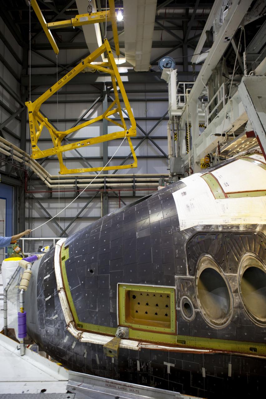 CAPE CANAVERAL, Fla. – In Orbiter Processing Facility-2 at NASA’s Kennedy Space Center in Florida, a large crane is lifted away after it was used to lower the forward reaction control system (FRCS) for installation on space shuttle Endeavour. The work is part of the Space Shuttle Program transition and retirement processing of Endeavour. The FRCS helped maneuver a shuttle while it was in orbit. The FRCS was removed from Endeavour and sent to White Sands Test Facility in N.M. to be cleaned of its toxic propellants. Endeavour is being prepared for display at the California Science Center in Los Angeles. Photo credit: NASA/Dimitri Gerondidakis