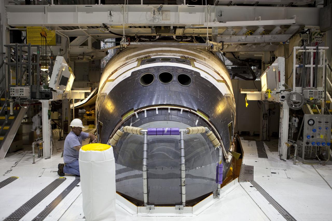 CAPE CANAVERAL, Fla. – In Orbiter Processing Facility-2 at NASA’s Kennedy Space Center in Florida, one of several technicians installs the forward reaction control system (FRCS) on space shuttle Endeavour. The work is part of the Space Shuttle Program transition and retirement processing of Endeavour. The FRCS helped maneuver a shuttle while it was in orbit. The FRCS was removed from Endeavour and sent to White Sands Test Facility in N.M. to be cleaned of its toxic propellants. Endeavour is being prepared for display at the California Science Center in Los Angeles. Photo credit: NASA/Dimitri Gerondidakis