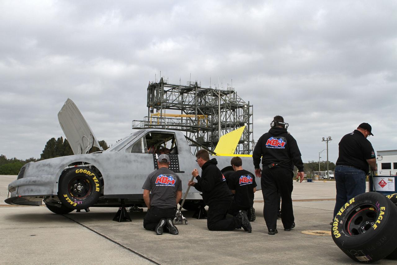CAPE CANAVERAL, Fla. - At NASA’s Kennedy Space Center in Florida, NASCAR racer Jason Leffler’s instrument-laden vehicle is being prepared for its three-mile-long drive down the Shuttle Landing Facility runway. The operation is part of Kyle Busch Motorsports’ program to test aerodynamic and real-world capabilities on one of the flattest surfaces in the world.      Racing teams have been using the runway for testing since 2008. KBM signed a Space Act Agreement with NASA to use the facility’s runway. Photo Credit: NASA/Kim Shiflett