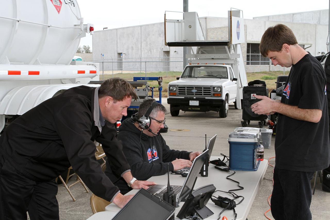 CAPE CANAVERAL, Fla. - At NASA’s Kennedy Space Center in Florida, members of Kyle Busch Motorsports (KBM) team monitor screens as NASCAR racer Jason Leffler with KBM prepares to drive his instrument-laden vehicle down the three-mile-long Shuttle Landing Facility runway. The operation is part of KBMs’ program to test aerodynamic and real-world capabilities on one of the flattest surfaces in the world.      Racing teams have been using the runway for testing since 2008. KBM signed a Space Act Agreement with NASA to use the facility’s runway. Photo Credit: NASA/Kim Shiflett