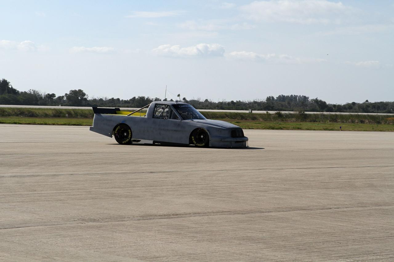 CAPE CANAVERAL, Fla. - At NASA’s Kennedy Space Center in Florida, NASCAR racer Jason Leffler with Kyle Busch Motorsports (KBM) drives his instrument-laden vehicle back from the three-mile-long drive down the Shuttle Landing Facility runway. The operation is part of KBMs’ program to test aerodynamic and real-world capabilities on one of the flattest surfaces in the world.    Racing teams have been using the runway for testing since 2008. KBM signed a Space Act Agreement with NASA to use the facility’s runway. Photo Credit: NASA/Kim Shiflett