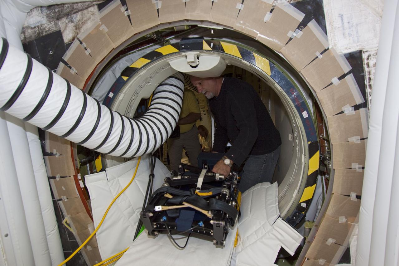 CAPE CANAVERAL, Fla. -- Inside Orbiter Processing Facility-1 at NASA’s Kennedy Space Center in Florida, technicians prepare to reinstall the seats in the middeck of space shuttle Discovery.    The work is part of the Space Shuttle Program’s transition and retirement processing of shuttle Discovery, which is being prepared for display at Smithsonian’s National Air and Space Museum, Steven F. Udvar-Hazy Center in Chantilly, Va. Discovery is scheduled to be transported atop a NASA Shuttle Carrier Aircraft modified 747 jet to Dulles International Airport in Virginia on April 17 and then be transported to the Smithsonian on April 19. For more information, visit http://www.nasa.gov/shuttle.  Photo credit: NASA/Jim Grossmann