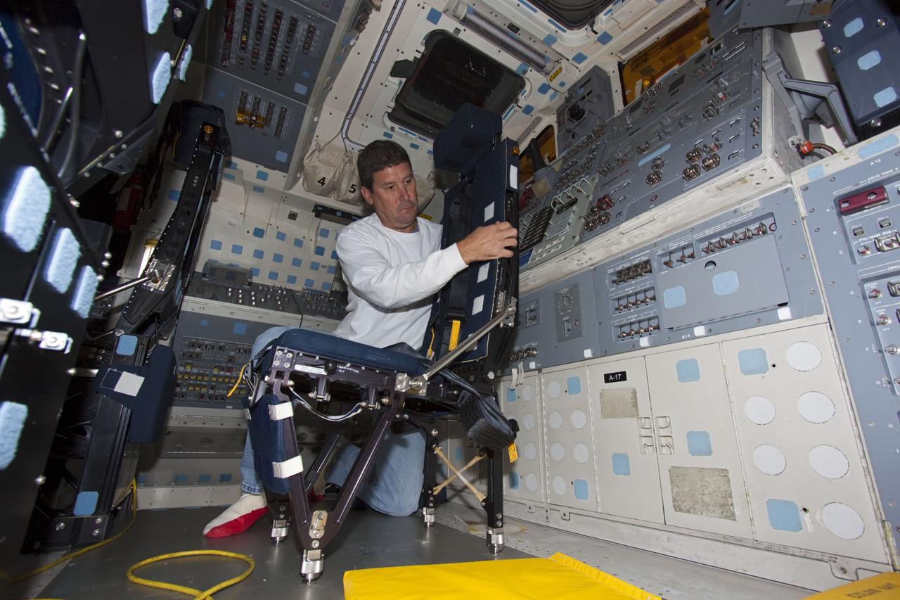 CAPE CANAVERAL, Fla. -- Inside Orbiter Processing Facility-1 at NASA’s Kennedy Space Center in Florida, a technician reinstalls a seat in the middeck of space shuttle Discovery.    The work is part of the Space Shuttle Program’s transition and retirement processing of shuttle Discovery, which is being prepared for display at Smithsonian’s National Air and Space Museum, Steven F. Udvar-Hazy Center in Chantilly, Va. Discovery is scheduled to be transported atop a NASA Shuttle Carrier Aircraft modified 747 jet to Dulles International Airport in Virginia on April 17 and then be transported to the Smithsonian on April 19. For more information, visit http://www.nasa.gov/shuttle.  Photo credit: NASA/Jim Grossmann