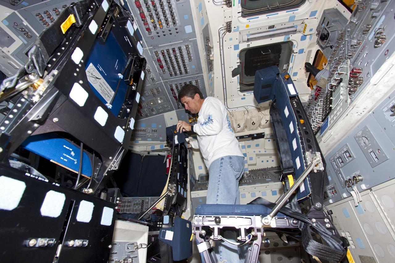 CAPE CANAVERAL, Fla. -- Inside Orbiter Processing Facility-1 at NASA’s Kennedy Space Center in Florida, a technician reinstalls one of the seats in the middeck of space shuttle Discovery.    The work is part of the Space Shuttle Program’s transition and retirement processing of shuttle Discovery, which is being prepared for display at Smithsonian’s National Air and Space Museum, Steven F. Udvar-Hazy Center in Chantilly, Va. Discovery is scheduled to be transported atop a NASA Shuttle Carrier Aircraft modified 747 jet to Dulles International Airport in Virginia on April 17 and then be transported to the Smithsonian on April 19. For more information, visit http://www.nasa.gov/shuttle.  Photo credit: NASA/Jim Grossmann