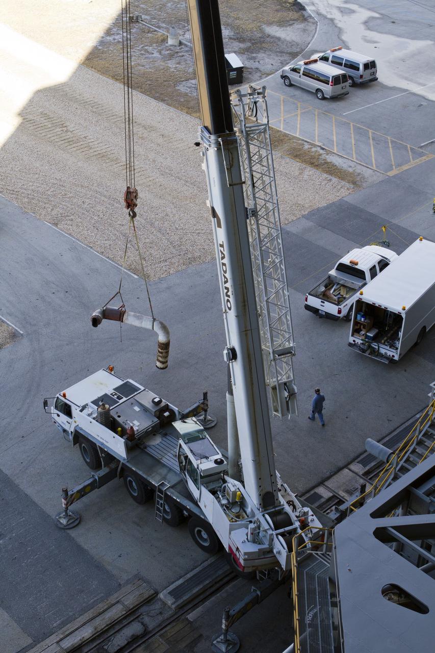 CAPE CANAVERAL, Fla. –– Inside the Vehicle Assembly Building at NASA’s Kennedy Space Center in Florida, a crane operator lifts part of an Apollo era diesel engine away from crawler-transporter 2 CT-2). New engines will be installed later this month. Work is in progress in high bay 2 to upgrade CT-2 so that it can carry NASA’s Space Launch System heavy-lift rocket, which is under design, and new Orion spacecraft to the launch pad. The crawler-transporters were used to carry the mobile launcher platform and space shuttle to Launch Complex 39 for space shuttle launches for 30 years. Photo credit: NASA/Kim Shiflett