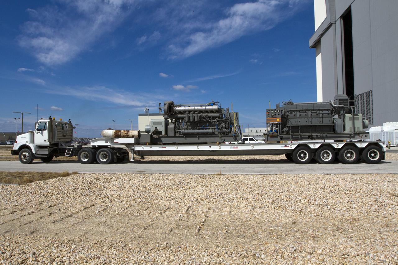 CAPE CANAVERAL, Fla. –– Just outside of the Vehicle Assembly Building at NASA’s Kennedy Space Center in Florida, an Apollo era diesel engine is secured onto the flatbed of a truck after it was removed from crawler-transporter 2 CT-2). New engines will be installed later this month. Work is in progress in high bay 2 to upgrade CT-2 so that it can carry NASA’s Space Launch System heavy-lift rocket, which is under design, and new Orion spacecraft to the launch pad. The crawler-transporters were used to carry the mobile launcher platform and space shuttle to Launch Complex 39 for space shuttle launches for 30 years. Photo credit: NASA/Kim Shiflett