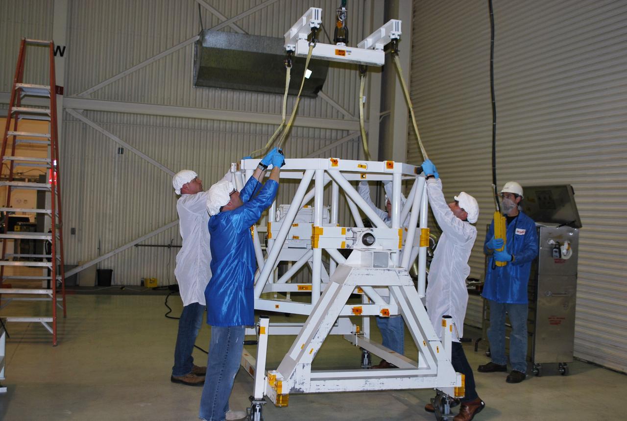 VANDENBERG AIR FORCE BASE, Calif. -- At Vandenberg Air Force Base in California, technicians inside Orbital Sciences' processing facility prepare NASA's NuSTAR spacecraft and place it into a tilt-rotation fixture. The spacecraft will be rotated to horizontal for joining with the Pegasus XL rocket. The Orbital Sciences Pegasus will launch NASA's Nuclear Spectroscopic Telescope Array NuSTAR into space. After the rocket and spacecraft are processed at Vandenberg, they will be flown on Orbital's L-1011 carrier aircraft to the Ronald Reagan Ballistic Missile Defense Test Site at the Pacific Ocean’s Kwajalein Atoll for launch. The high-energy x-ray telescope will conduct a census for black holes, map radioactive material in young supernovae remnants, and study the origins of cosmic rays and the extreme physics around collapsed stars. For more information, visit science.nasa.gov/missions/nustar/. Photo credit: NASA/Randy Beaudoin, VAFB