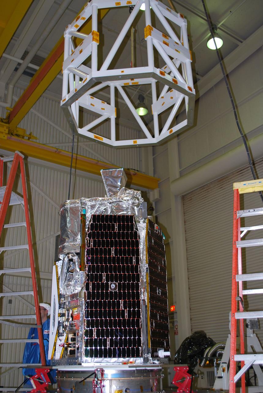 VANDENBERG AIR FORCE BASE, Calif. -- Inside Orbital Sciences' processing facility at Vandenberg Air Force Base in California, a lifting device is lowered toward NASA's NuSTAR spacecraft. The spacecraft will be rotated to horizontal for joining with the Pegasus XL rocket. The Orbital Sciences Pegasus will launch NASA's Nuclear Spectroscopic Telescope Array NuSTAR into space. After the rocket and spacecraft are processed at Vandenberg, they will be flown on Orbital's L-1011 carrier aircraft to the Ronald Reagan Ballistic Missile Defense Test Site at the Pacific Ocean’s Kwajalein Atoll for launch. The high-energy x-ray telescope will conduct a census for black holes, map radioactive material in young supernovae remnants, and study the origins of cosmic rays and the extreme physics around collapsed stars. For more information, visit science.nasa.gov/missions/nustar/. Photo credit: NASA/Randy Beaudoin, VAFB