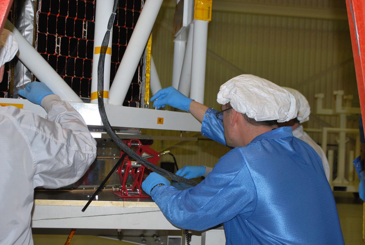 VANDENBERG AIR FORCE BASE, Calif. -- Inside Orbital Sciences' processing facility at Vandenberg Air Force Base in California, technicians begin attaching the lifting device that will place NASA's NuSTAR spacecraft into the tilt-rotation fixture. The spacecraft will be rotated to horizontal for joining with the Pegasus XL rocket. The Orbital Sciences Pegasus will launch NASA's Nuclear Spectroscopic Telescope Array NuSTAR into space. After the rocket and spacecraft are processed at Vandenberg, they will be flown on Orbital's L-1011 carrier aircraft to the Ronald Reagan Ballistic Missile Defense Test Site at the Pacific Ocean’s Kwajalein Atoll for launch. The high-energy x-ray telescope will conduct a census for black holes, map radioactive material in young supernovae remnants, and study the origins of cosmic rays and the extreme physics around collapsed stars. For more information, visit science.nasa.gov/missions/nustar/. Photo credit: NASA/Randy Beaudoin, VAFB