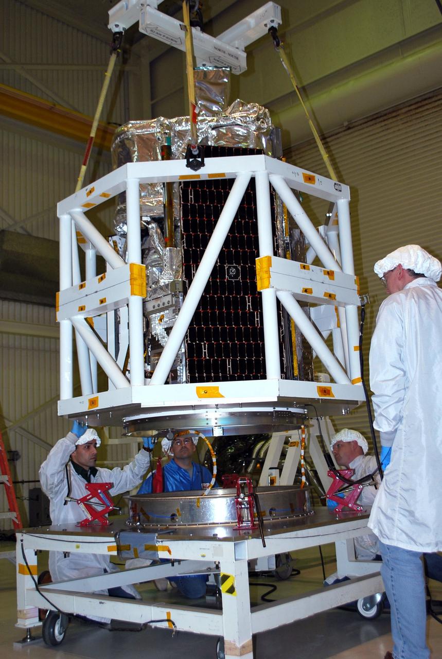 VANDENBERG AIR FORCE BASE, Calif. -- Technicians watch closely as NASA's NuSTAR spacecraft is Under the watchful eyes of technicians, NASA's NuSTAR spacecraft is lifted inside Orbital Sciences' processing facility at Vandenberg Air Force Base, Calif. The spacecraft will be rotated to horizontal for joining with the Pegasus XL rocket. The Orbital Sciences Pegasus will launch NASA's Nuclear Spectroscopic Telescope Array NuSTAR into space. After the rocket and spacecraft are processed at Vandenberg, they will be flown on Orbital's L-1011 carrier aircraft to the Ronald Reagan Ballistic Missile Defense Test Site at the Pacific Ocean’s Kwajalein Atoll for launch. The high-energy x-ray telescope will conduct a census for black holes, map radioactive material in young supernovae remnants, and study the origins of cosmic rays and the extreme physics around collapsed stars. For more information, visit science.nasa.gov/missions/nustar/. Photo credit: NASA/Randy Beaudoin, VAFB