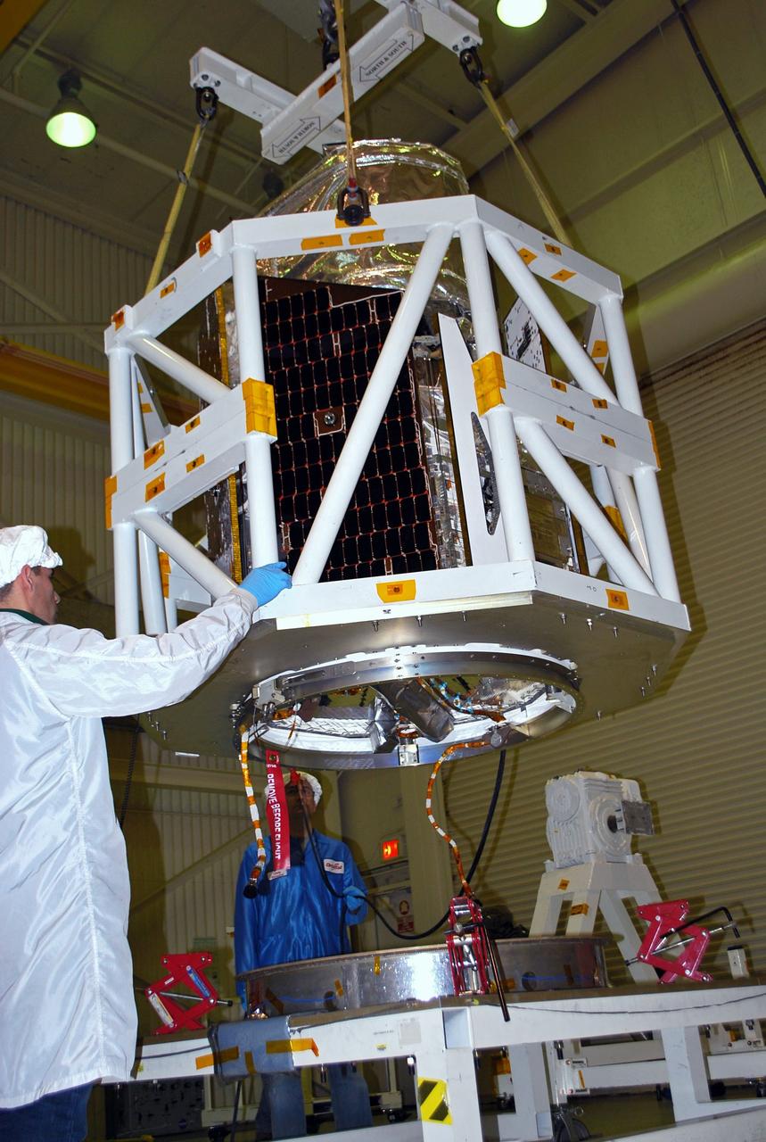 VANDENBERG AIR FORCE BASE, Calif. -- At Vandenberg Air Force Base in California, technicians inside Orbital Sciences' processing facility watch as NASA's NuSTAR spacecraft is lifted by the tilt-rotation fixture. The spacecraft will be rotated to horizontal for joining with the Pegasus XL rocket. The Orbital Sciences Pegasus will launch NASA's Nuclear Spectroscopic Telescope Array NuSTAR into space. After the rocket and spacecraft are processed at Vandenberg, they will be flown on Orbital's L-1011 carrier aircraft to the Ronald Reagan Ballistic Missile Defense Test Site at the Pacific Ocean’s Kwajalein Atoll for launch. The high-energy x-ray telescope will conduct a census for black holes, map radioactive material in young supernovae remnants, and study the origins of cosmic rays and the extreme physics around collapsed stars. For more information, visit science.nasa.gov/missions/nustar/. Photo credit: NASA/Randy Beaudoin, VAFB