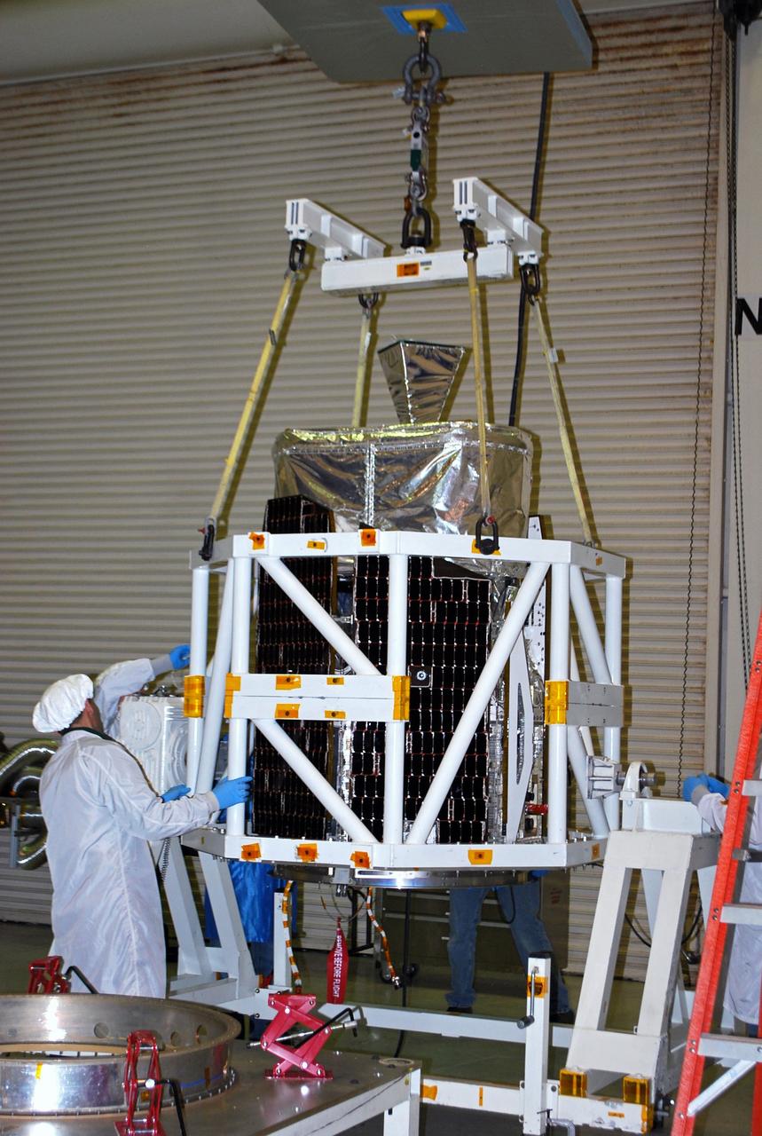 VANDENBERG AIR FORCE BASE, Calif. -- At Vandenberg Air Force Base in California, technicians inside Orbital Sciences' processing facility guide the lifting device as NASA's NuSTAR spacecraft is placed into a tilt-rotation fixture. The spacecraft will be rotated to horizontal for joining with the Pegasus XL rocket. The Orbital Sciences Pegasus will launch NASA's Nuclear Spectroscopic Telescope Array NuSTAR into space. After the rocket and spacecraft are processed at Vandenberg, they will be flown on Orbital's L-1011 carrier aircraft to the Ronald Reagan Ballistic Missile Defense Test Site at the Pacific Ocean’s Kwajalein Atoll for launch. The high-energy x-ray telescope will conduct a census for black holes, map radioactive material in young supernovae remnants, and study the origins of cosmic rays and the extreme physics around collapsed stars. For more information, visit science.nasa.gov/missions/nustar/. Photo credit: NASA/Randy Beaudoin, VAFB