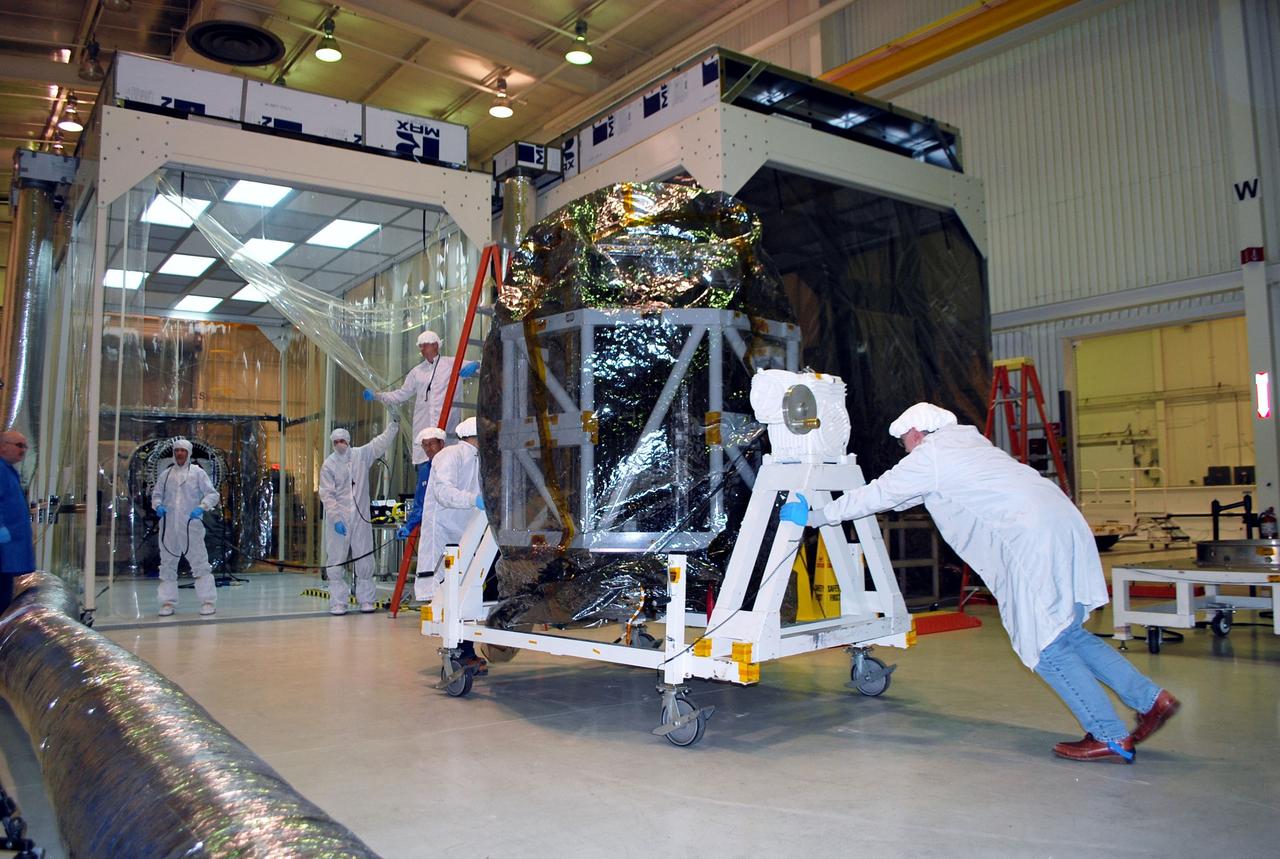 VANDENBERG AIR FORCE BASE, Calif. -- Technicians move the tilt-rotation fixture holding NASA's NuSTAR spacecraft inside Orbital Sciences' processing facility at Vandenberg Air Force Base, Calif. The spacecraft will be rotated to horizontal for joining with the Pegasus XL rocket. The Orbital Sciences Pegasus will launch NASA's Nuclear Spectroscopic Telescope Array NuSTAR into space. After the rocket and spacecraft are processed at Vandenberg, they will be flown on Orbital's L-1011 carrier aircraft to the Ronald Reagan Ballistic Missile Defense Test Site at the Pacific Ocean’s Kwajalein Atoll for launch. The high-energy x-ray telescope will conduct a census for black holes, map radioactive material in young supernovae remnants, and study the origins of cosmic rays and the extreme physics around collapsed stars. For more information, visit science.nasa.gov/missions/nustar/. Photo credit: NASA/Randy Beaudoin, VAFB