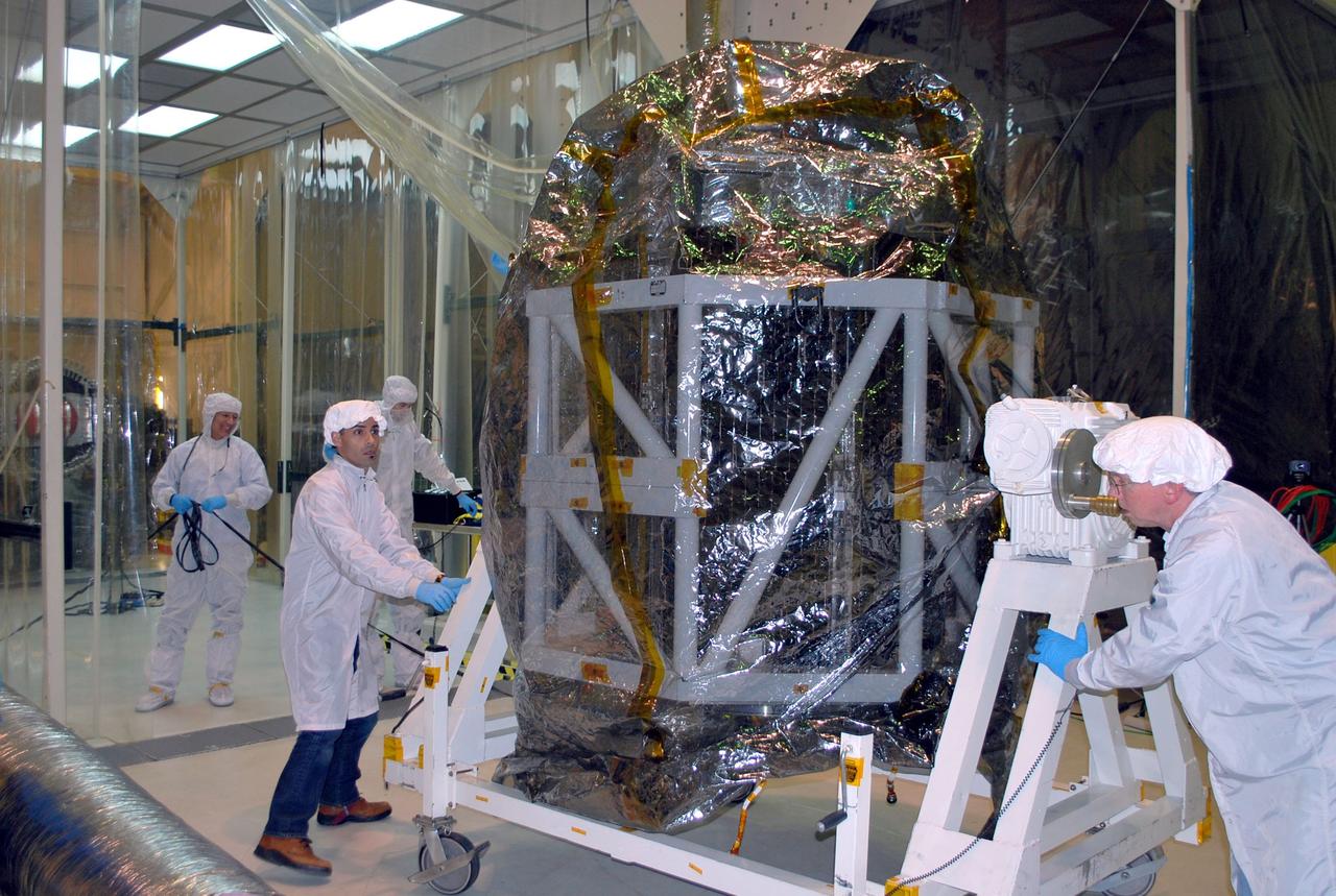 VANDENBERG AIR FORCE BASE, Calif. -- Technicians move the tilt-rotation fixture holding NASA's NuSTAR spacecraft inside Orbital Sciences' processing facility at Vandenberg Air Force Base, Calif. The spacecraft will be rotated to horizontal for joining with the Pegasus XL rocket. The Orbital Sciences Pegasus will launch NASA's Nuclear Spectroscopic Telescope Array NuSTAR into space. After the rocket and spacecraft are processed at Vandenberg, they will be flown on Orbital's L-1011 carrier aircraft to the Ronald Reagan Ballistic Missile Defense Test Site at the Pacific Ocean’s Kwajalein Atoll for launch. The high-energy x-ray telescope will conduct a census for black holes, map radioactive material in young supernovae remnants, and study the origins of cosmic rays and the extreme physics around collapsed stars. For more information, visit science.nasa.gov/missions/nustar/. Photo credit: NASA/Randy Beaudoin, VAFB