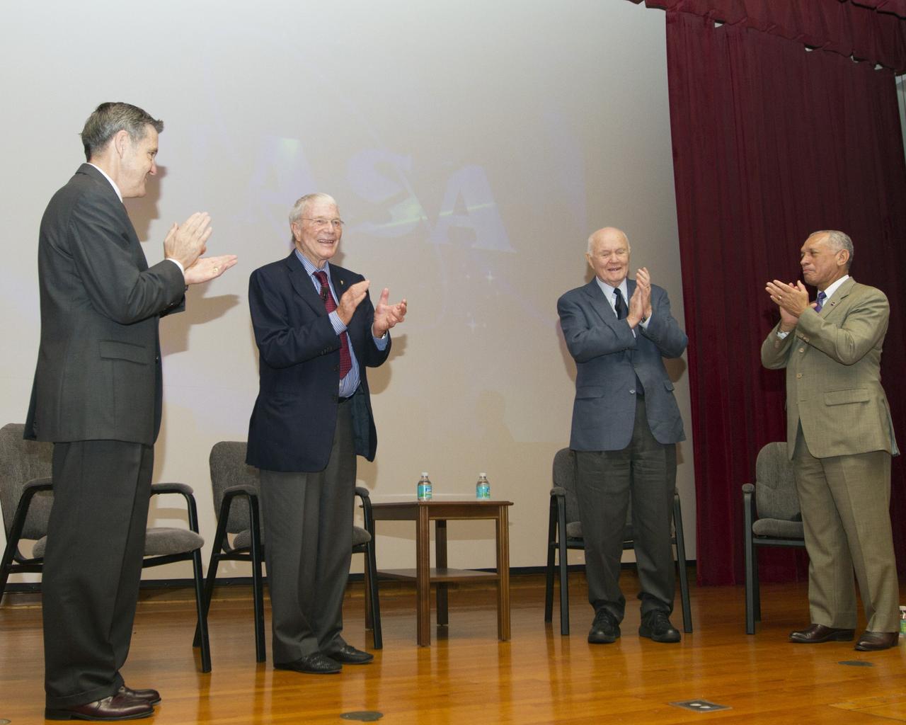 CAPE CANAVERAL, Fla. -- At NASA's Kennedy Space Center in Florida, Center Director Bob Cabana, left, Mercury astronauts Scott Carpenter and John Glenn, and NASA Administrator Charles Bolden applaud during the "50 Years of Americans in Orbit" presentation for Kennedy employees. This year marks 50 years since Glenn and Carpenter became the first two Americans to orbit Earth. Photo credit: NASA/Kim Shiflett