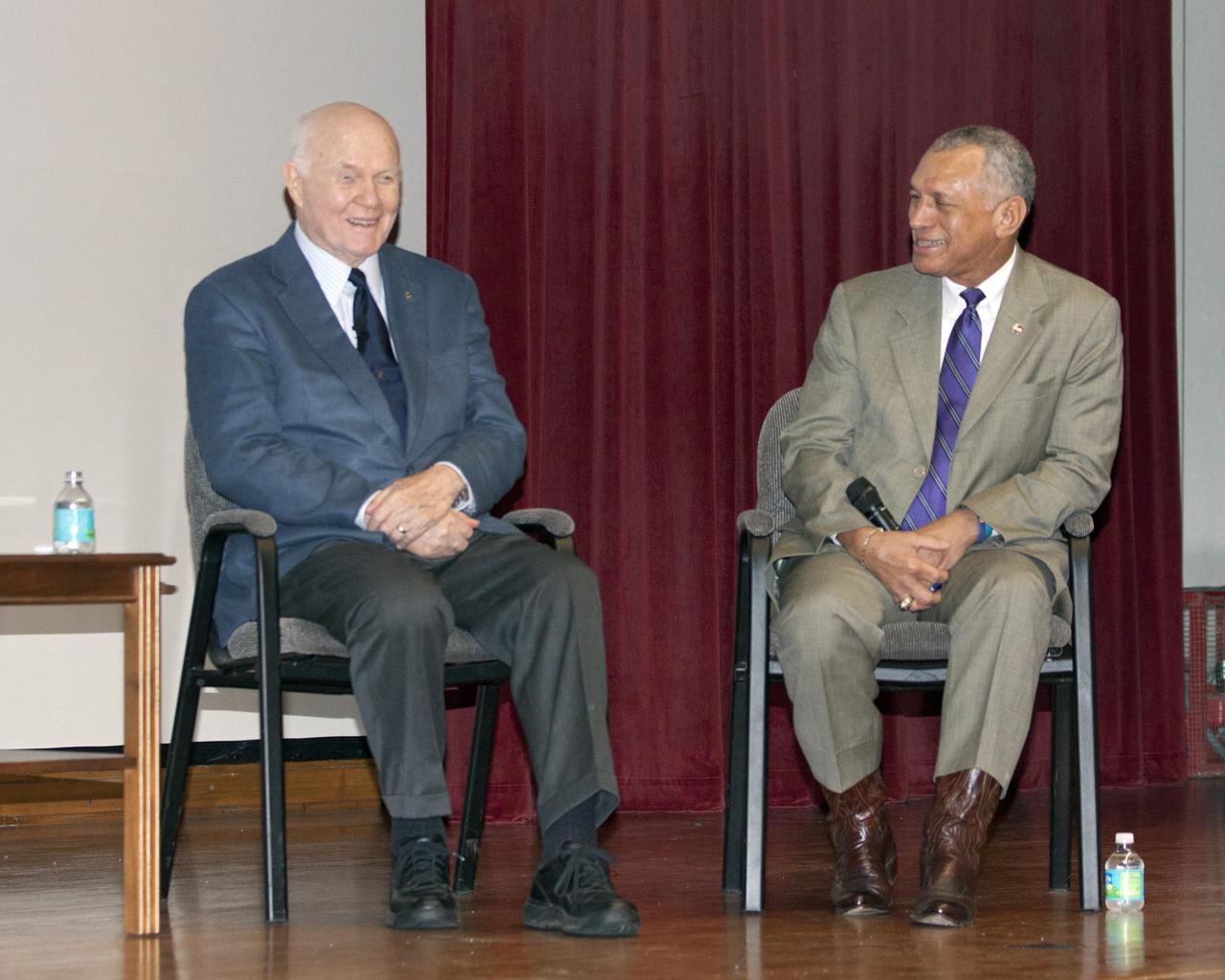 CAPE CANAVERAL, Fla. -- Mercury astronaut John Glenn, left, and NASA Administrator Charles Bolden share a laugh during the "50 Years of Americans in Orbit" presentation for employees at NASA's Kennedy Space Center in Florida. This year marks 50 years since Glenn and Carpenter became the first two Americans to orbit Earth. Photo credit: NASA/Kim Shiflett
