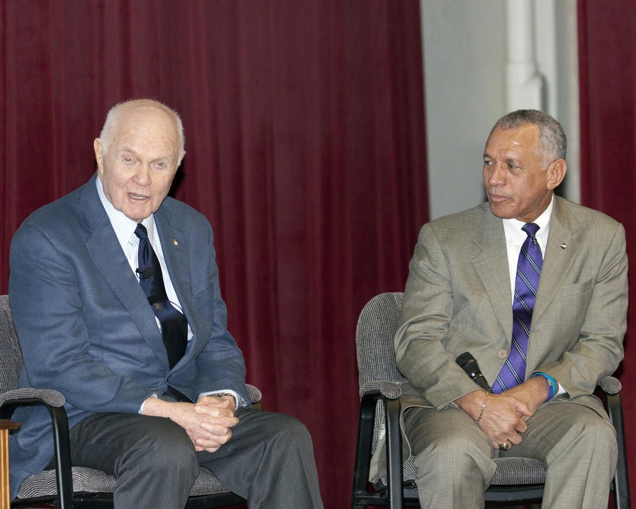 CAPE CANAVERAL, Fla. -- NASA Administrator Charles Bolden, right, listens as Mercury astronaut John Glenn speaks to employees during the "50 Years of Americans in Orbit" presentation at NASA's Kennedy Space Center in Florida.     This year marks 50 years since Glenn and Carpenter became the first two Americans to orbit Earth. Photo credit: NASA/Kim Shiflett