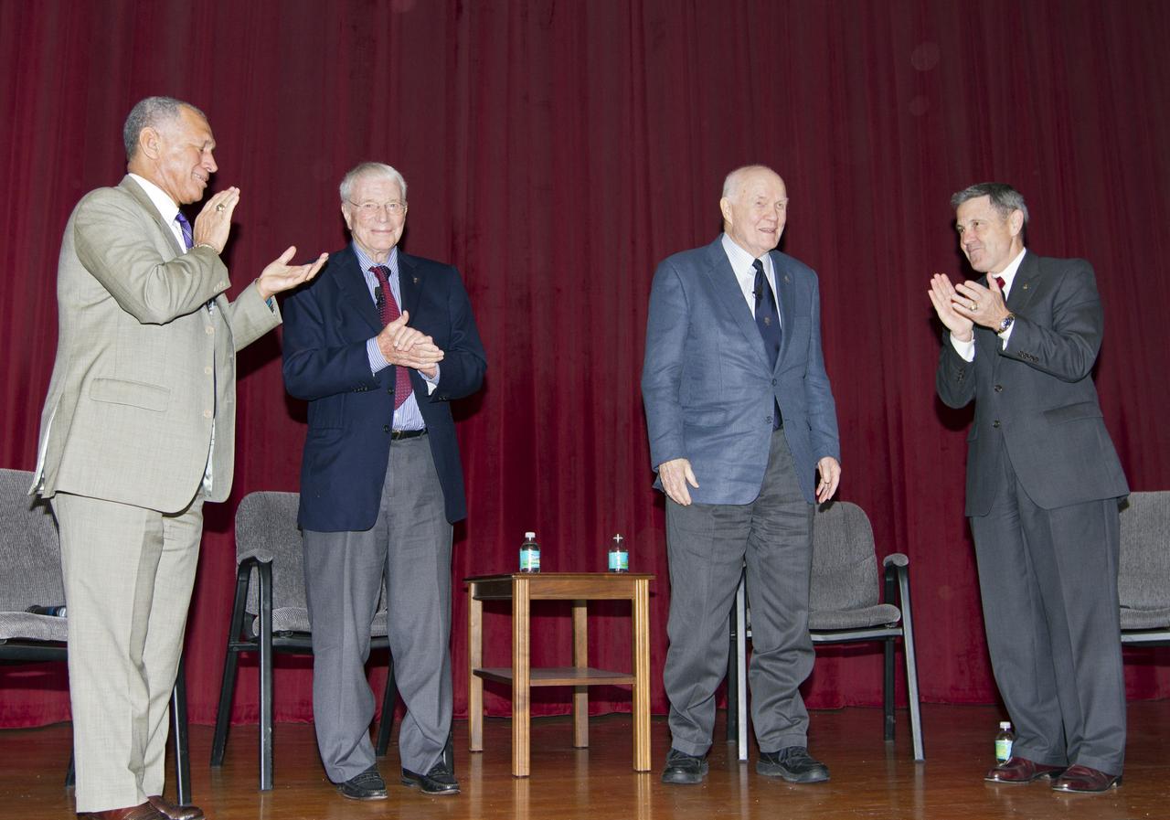 CAPE CANAVERAL, Fla. -- NASA Administrator Charles Bolden, Mercury astronauts Scott Carpenter and John Glenn, and Bob Cabana, director of NASA's Kennedy Space Center in Florida, stand for applause at the conclusion of the "50 Years of Americans in Orbit" presentation for Kennedy employees.     This year marks 50 years since Glenn and Carpenter became the first two Americans to orbit Earth. Photo credit: NASA/Kim Shiflett