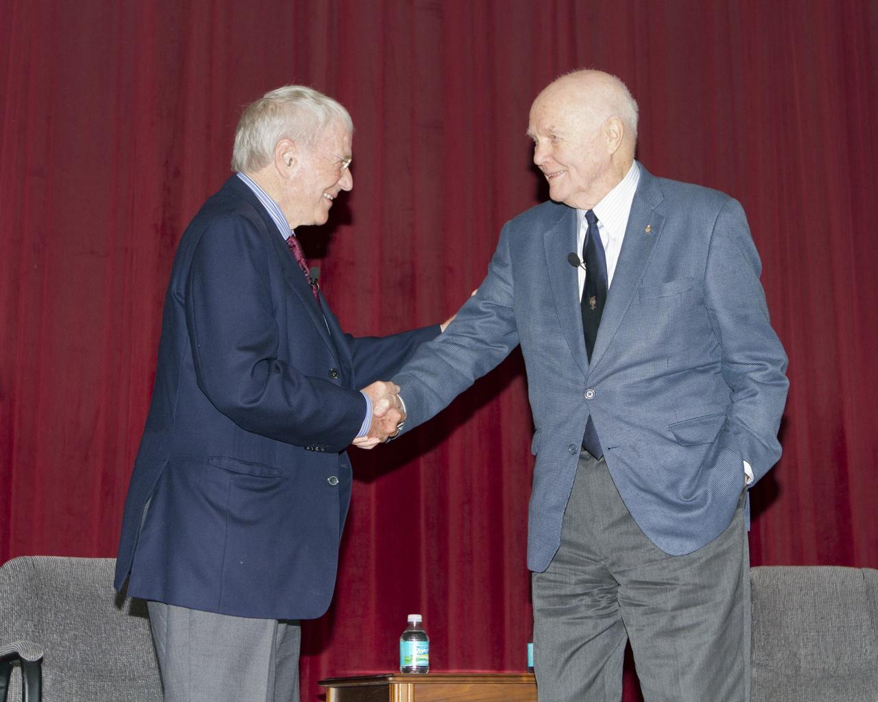CAPE CANAVERAL, Fla. -- Mercury astronauts Scott Carpenter and John Glenn pause for a handshake at the conclusion of the "50 Years of Americans in Orbit" presentation for employees at NASA's Kennedy Space Center in Florida. NASA Administrator Charles Bolden and Center Director Bob Cabana joined Carpenter and Glenn for the event.      This year marks 50 years since Glenn and Carpenter became the first two Americans to orbit Earth. Photo credit: NASA/Kim Shiflett