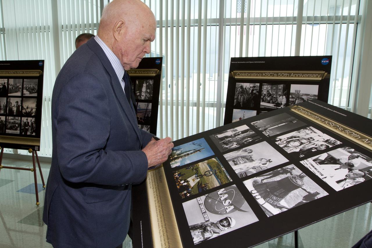 CAPE CANAVERAL, Fla. - Mercury astronaut John Glenn signs a poster celebrating 50 years of Americans in orbit, an era which began with Glenn's Mercury mission MA-6, on Feb. 20, 1962.  Glenn's launch aboard an Atlas rocket took with it the hopes of an entire nation and ushered in a new era of space travel that eventually led to Americans walking on the moon by the end of the 1960s. Glenn soon was followed into orbit by Scott Carpenter, Walter Schirra and Gordon Cooper. Their fellow Mercury astronauts Alan Shepard and Virgil "Gus" Grissom flew earlier suborbital flights. Deke Slayton, a member of NASA's original Mercury 7 astronauts, was grounded by a medical condition until the Apollo-Soyuz Test Project in 1975. Photo credit: NASA/Kim Shiflett