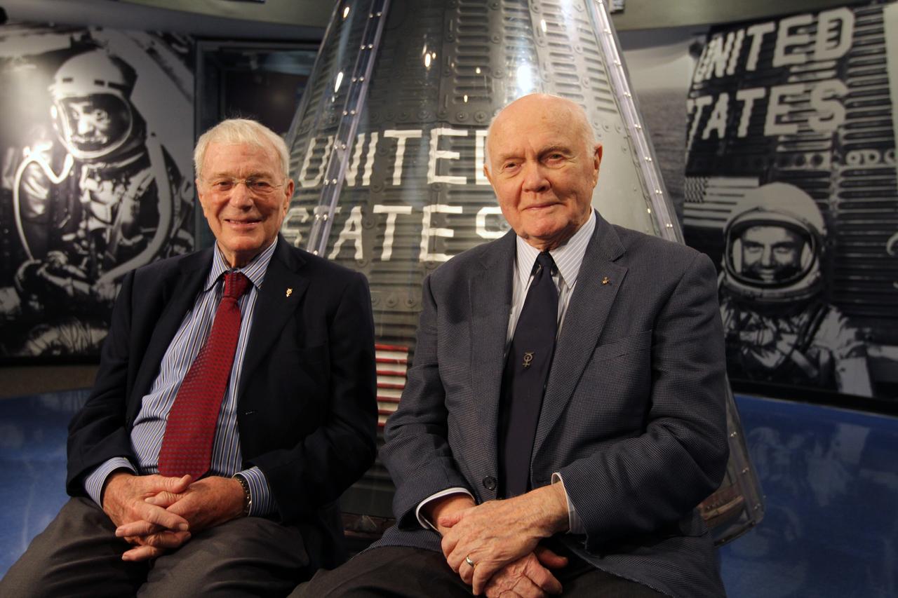 CAPE CANAVERAL, Fla. -- Mercury astronauts Scott Carpenter, left, and John Glenn sit in front of a capsule from the Mercury program on display at the Kennedy Space Center Visitor Complex in Florida. The two astronauts, part of the original class of seven astronauts chosen by NASA, were taking part in events celebrating 50 years of Americans in orbit, an era which began with Glenn's Mercury mission MA-6, on Feb. 20, 1962.  Glenn's launch aboard an Atlas rocket took with it the hopes of an entire nation and ushered in a new era of space travel that eventually led to Americans walking on the moon by the end of the 1960s. Glenn soon was followed into orbit by Carpenter, Walter Schirra and Gordon Cooper. Their fellow Mercury astronauts Alan Shepard and Virgil "Gus" Grissom flew earlier suborbital flights. Deke Slayton was grounded by a medical condition until the Apollo-Soyuz Test Project in 1975. Photo credit: NASA/Kim Shiflett
