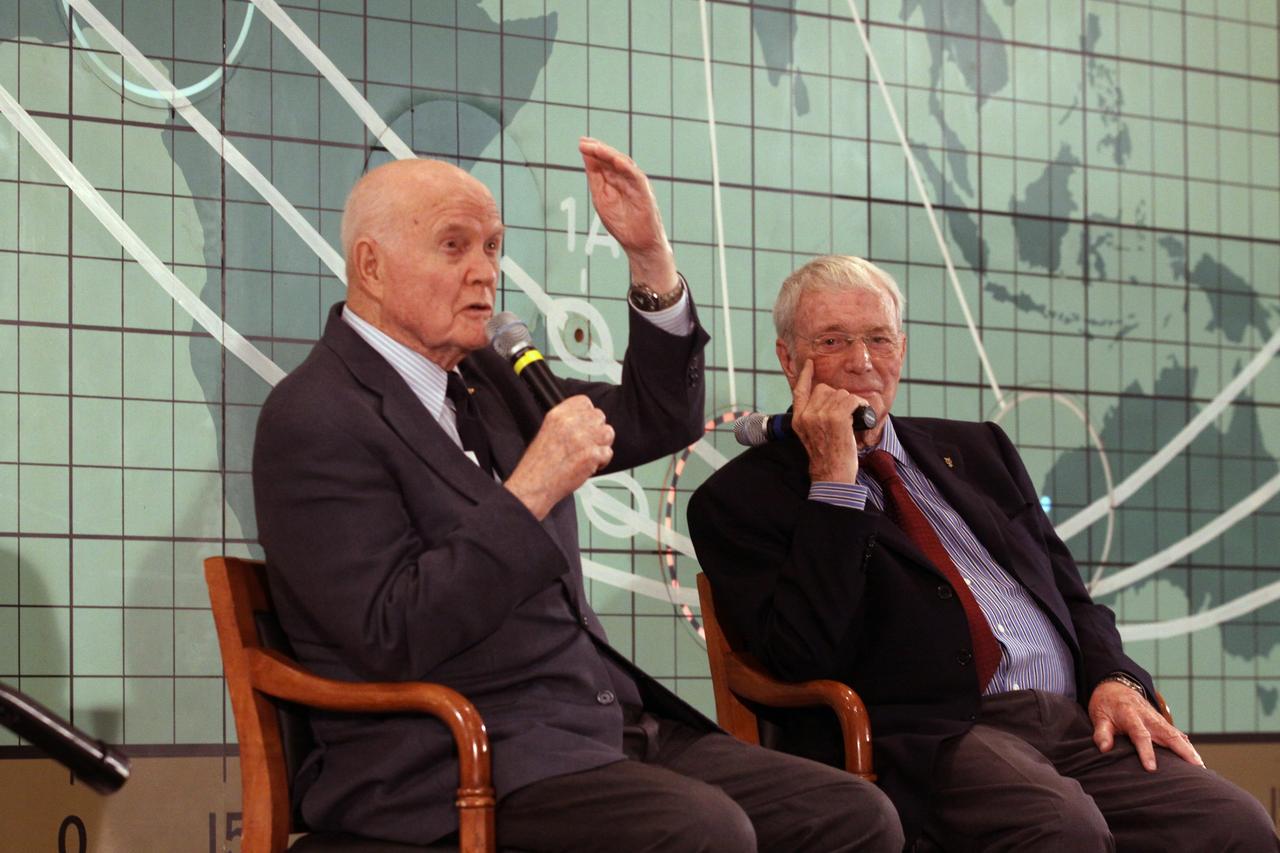 CAPE CANAVERAL, Fla. --Mercury astronauts John Glenn, left, and Scott Carpenter sit in front of the plot board from the Mercury control center on display at the Kennedy Space Center Visitor Complex. The astronauts, part of the original class of seven astronauts chosen by NASA, were taking part in a question-and-answer session with the media as part of events celebrating 50 years of Americans in orbit, an era which began with John Glenn's Mercury mission MA-6, on Feb. 20, 1962.  Glenn's launch aboard an Atlas rocket took with it the hopes of an entire nation and ushered in a new era of space travel that eventually led to Americans walking on the moon by the end of the 1960s. Glenn soon was followed into orbit by Carpenter, Walter Schirra and Gordon Cooper. Their fellow Mercury astronauts Alan Shepard and Virgil "Gus" Grissom flew earlier suborbital flights. Deke Slayton was grounded by a medical condition until the Apollo-Soyuz Test Project in 1975. Photo credit: NASA/Kim Shiflett