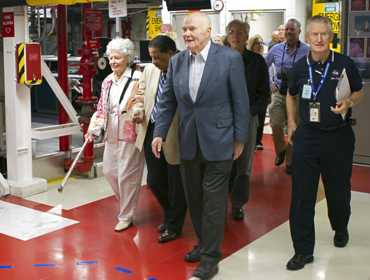 CAPE CANAVERAL, Fla. -- John Glenn and his wife, Annie, left, enter Orbiter Processing Facility-1 OPF-1 at NASA's Kennedy Space Center in Florida where space shuttle Discovery is being prepared for public display. Glenn is at the space center to mark the 50th anniversary of being the first American astronaut to orbit the Earth inside the NASA Mercury Project's Friendship 7 capsule on Feb. 20, 1962. Glenn later returned to space in October 1998 as a payload specialist aboard Discovery's STS-95 mission.             Glenn's launch aboard an Atlas rocket took with it the hopes of an entire nation and ushered in a new era of space travel that eventually led to Americans walking on the moon by the end of the 1960s. Glenn soon was followed into orbit by Scott Carpenter, Walter Schirra and Gordon Cooper. Their fellow Mercury astronauts Alan Shepard and Virgil "Gus" Grissom flew earlier suborbital flights. Deke Slayton, a member of NASA's original Mercury 7 astronauts, was grounded by a medical condition until the Apollo-Soyuz Test Project in 1975. Shuttle Discovery currently is being prepared for display at Smithsonian’s National Air and Space Museum, Steven F. Udvar-Hazy Center in Chantilly, Va. Photo credit: Cory Huston