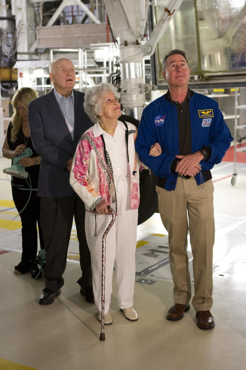 CAPE CANAVERAL, Fla. -- John Glenn and his wife, Annie, and NASA astronaut Stephen Robinson stand under space shuttle Discovery in Orbiter Processing Facility-1 OPF-1 at NASA's Kennedy Space Center in Florida. Glenn is at the space center to mark the 50th anniversary of being the first American astronaut to orbit the Earth inside the NASA Mercury Project's Friendship 7 capsule on Feb. 20, 1962. Glenn later returned to space in October 1998 as a payload specialist aboard Discovery's STS-95 mission. Robinson was the payload commander of STS-95.          Glenn's launch aboard an Atlas rocket took with it the hopes of an entire nation and ushered in a new era of space travel that eventually led to Americans walking on the moon by the end of the 1960s. Glenn soon was followed into orbit by Scott Carpenter, Walter Schirra and Gordon Cooper. Their fellow Mercury astronauts Alan Shepard and Virgil "Gus" Grissom flew earlier suborbital flights. Deke Slayton, a member of NASA's original Mercury 7 astronauts, was grounded by a medical condition until the Apollo-Soyuz Test Project in 1975. Shuttle Discovery currently is being prepared for display at Smithsonian’s National Air and Space Museum, Steven F. Udvar-Hazy Center in Chantilly, Va. Photo credit: Cory Huston