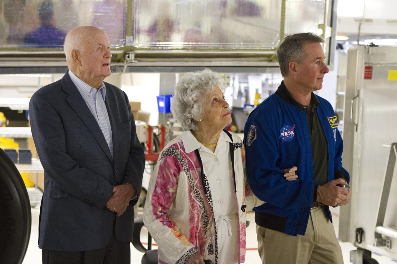CAPE CANAVERAL, Fla. -- John Glenn and his wife, Annie, and NASA astronaut Stephen Robinson stand under space shuttle Discovery in Orbiter Processing Facility-1 OPF-1 at NASA's Kennedy Space Center in Florida. Glenn is at the space center to mark the 50th anniversary of being the first American astronaut to orbit the Earth inside the NASA Mercury Project's Friendship 7 capsule on Feb. 20, 1962. Glenn later returned to space in October 1998 as a payload specialist aboard Discovery's STS-95 mission. Robinson was the payload commander of STS-95.        Glenn's launch aboard an Atlas rocket took with it the hopes of an entire nation and ushered in a new era of space travel that eventually led to Americans walking on the moon by the end of the 1960s. Glenn soon was followed into orbit by Scott Carpenter, Walter Schirra and Gordon Cooper. Their fellow Mercury astronauts Alan Shepard and Virgil "Gus" Grissom flew earlier suborbital flights. Deke Slayton, a member of NASA's original Mercury 7 astronauts, was grounded by a medical condition until the Apollo-Soyuz Test Project in 1975. Shuttle Discovery currently is being prepared for display at Smithsonian’s National Air and Space Museum, Steven F. Udvar-Hazy Center in Chantilly, Va. Photo credit: Cory Huston