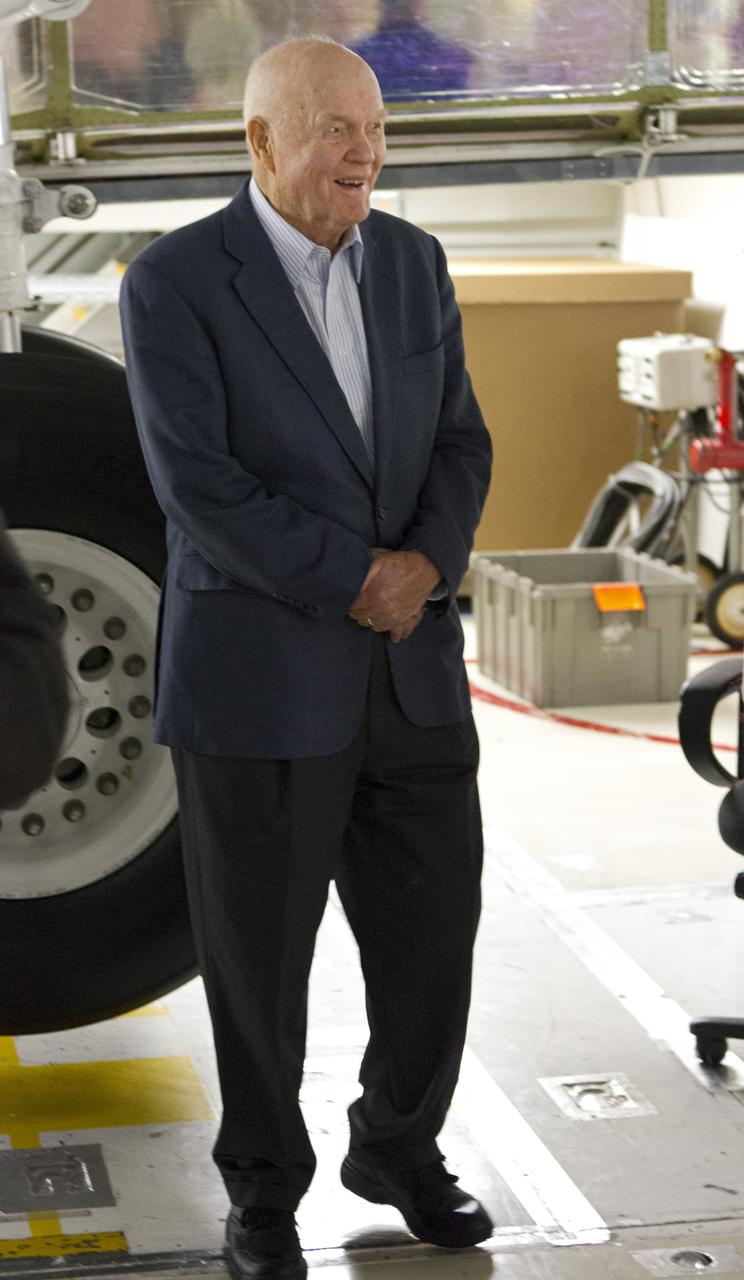 CAPE CANAVERAL, Fla. -- John Glenn stands beside the wheel of space shuttle Discovery in Orbiter Processing Facility-1 OPF-1 at NASA's Kennedy Space Center in Florida. Glenn is at the space center to mark the 50th anniversary of being the first American astronaut to orbit the Earth inside the NASA Mercury Project's Friendship 7 capsule on Feb. 20, 1962. Glenn later returned to space in October 1998 as a payload specialist aboard Discovery's STS-95 mission.         Glenn's launch aboard an Atlas rocket took with it the hopes of an entire nation and ushered in a new era of space travel that eventually led to Americans walking on the moon by the end of the 1960s. Glenn soon was followed into orbit by Scott Carpenter, Walter Schirra and Gordon Cooper. Their fellow Mercury astronauts Alan Shepard and Virgil "Gus" Grissom flew earlier suborbital flights. Deke Slayton, a member of NASA's original Mercury 7 astronauts, was grounded by a medical condition until the Apollo-Soyuz Test Project in 1975. Shuttle Discovery currently is being prepared for display at Smithsonian’s National Air and Space Museum, Steven F. Udvar-Hazy Center in Chantilly, Va. Photo credit: Cory Huston