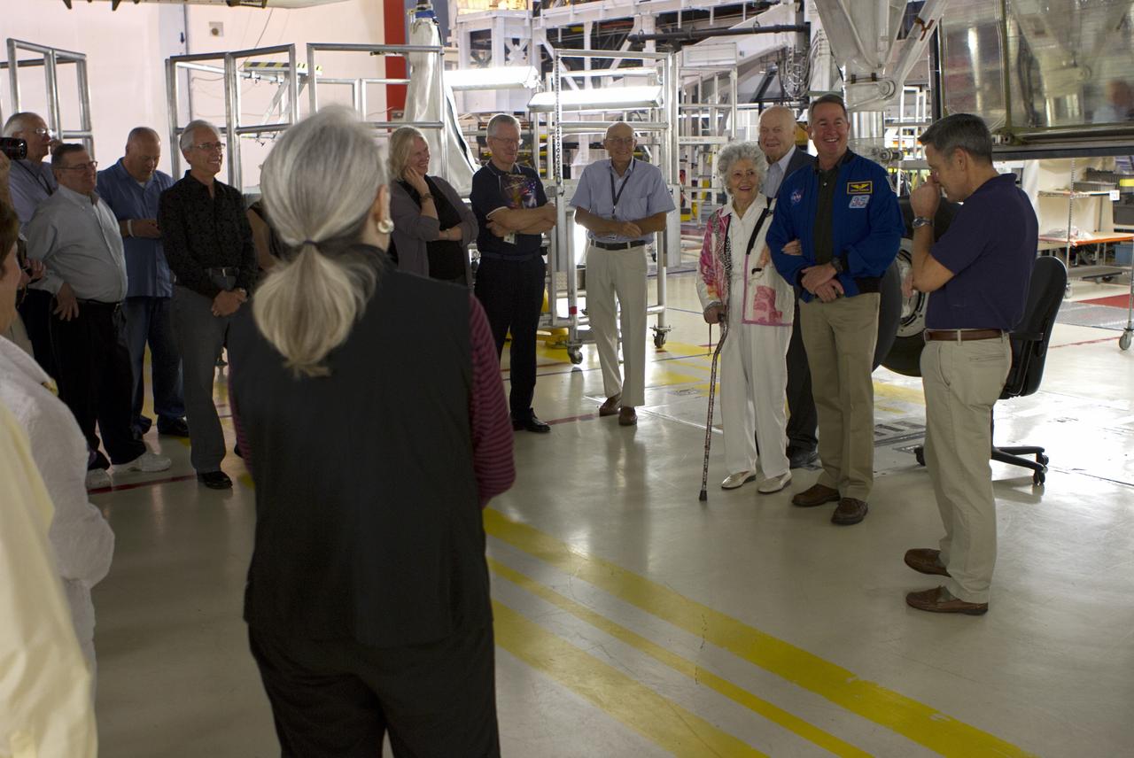 CAPE CANAVERAL, Fla. -- NASA Kennedy Space Center Director Bob Cabana, right, talks to guests in Orbiter Processing Facility-1 OPF-1 where space shuttle Discovery is being prepared for public display during a 50th anniversary celebration of the first orbital flight of an American. The astronaut who made that first flight, John Glenn, is at the space center to commemorate that achievement. Glenn orbited the Earth three times in the NASA Mercury Project's Friendship 7 capsule on Feb. 20, 1962. He later returned to space in October 1998 as a payload specialist aboard Discovery's STS-95 mission. Also in the photo are Glenn's wife, Annie, NASA astronaut Stephen Robinson, and Bob Sieck, a former shuttle launch director. Robinson was the payload commander of STS-95.      Glenn's launch aboard an Atlas rocket took with it the hopes of an entire nation and ushered in a new era of space travel that eventually led to Americans walking on the moon by the end of the 1960s. Glenn soon was followed into orbit by Scott Carpenter, Walter Schirra and Gordon Cooper. Their fellow Mercury astronauts Alan Shepard and Virgil "Gus" Grissom flew earlier suborbital flights. Deke Slayton, a member of NASA's original Mercury 7 astronauts, was grounded by a medical condition until the Apollo-Soyuz Test Project in 1975. Shuttle Discovery currently is being prepared for display at Smithsonian’s National Air and Space Museum, Steven F. Udvar-Hazy Center in Chantilly, Va. Photo credit: Cory Huston