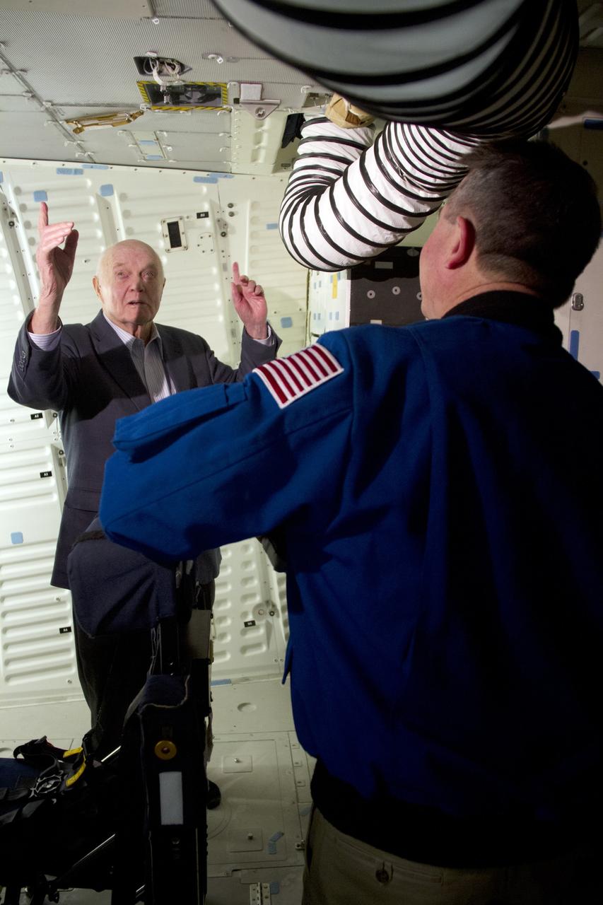 CAPE CANAVERAL, Fla. -- John Glenn and NASA astronaut Stephen Robinson stand in the middeck of space shuttle Discovery in Orbiter Processing Facility-1 OPF-1 at NASA's Kennedy Space Center in Florida. Glenn is at the space center to mark the 50th anniversary of being the first American astronaut to orbit the Earth inside the NASA Mercury Project's Friendship 7 capsule on Feb. 20, 1962. Glenn later returned to space in October 1998 as a payload specialist aboard Discovery's STS-95 mission. Robinson was the payload commander of STS-95.          Glenn's launch aboard an Atlas rocket took with it the hopes of an entire nation and ushered in a new era of space travel that eventually led to Americans walking on the moon by the end of the 1960s. Glenn soon was followed into orbit by Scott Carpenter, Walter Schirra and Gordon Cooper. Their fellow Mercury astronauts Alan Shepard and Virgil "Gus" Grissom flew earlier suborbital flights. Deke Slayton, a member of NASA's original Mercury 7 astronauts, was grounded by a medical condition until the Apollo-Soyuz Test Project in 1975. Shuttle Discovery currently is being prepared for display at Smithsonian’s National Air and Space Museum, Steven F. Udvar-Hazy Center in Chantilly, Va. Photo credit: Cory Huston