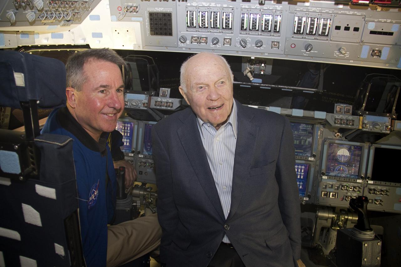 CAPE CANAVERAL, Fla. -- John Glenn and NASA astronaut Stephen Robinson sit in the flight deck of space shuttle Discovery in Orbiter Processing Facility-1 OPF-1 at NASA's Kennedy Space Center in Florida. Glenn is at the space center to mark the 50th anniversary of being the first American astronaut to orbit the Earth inside the NASA Mercury Project's Friendship 7 capsule on Feb. 20, 1962. Glenn later returned to space in October 1998 as a payload specialist aboard Discovery's STS-95 mission. Robinson was the payload commander of STS-95.        Glenn's launch aboard an Atlas rocket took with it the hopes of an entire nation and ushered in a new era of space travel that eventually led to Americans walking on the moon by the end of the 1960s. Glenn soon was followed into orbit by Scott Carpenter, Walter Schirra and Gordon Cooper. Their fellow Mercury astronauts Alan Shepard and Virgil "Gus" Grissom flew earlier suborbital flights. Deke Slayton, a member of NASA's original Mercury 7 astronauts, was grounded by a medical condition until the Apollo-Soyuz Test Project in 1975. Shuttle Discovery currently is being prepared for display at Smithsonian’s National Air and Space Museum, Steven F. Udvar-Hazy Center in Chantilly, Va. Photo credit: Cory Huston