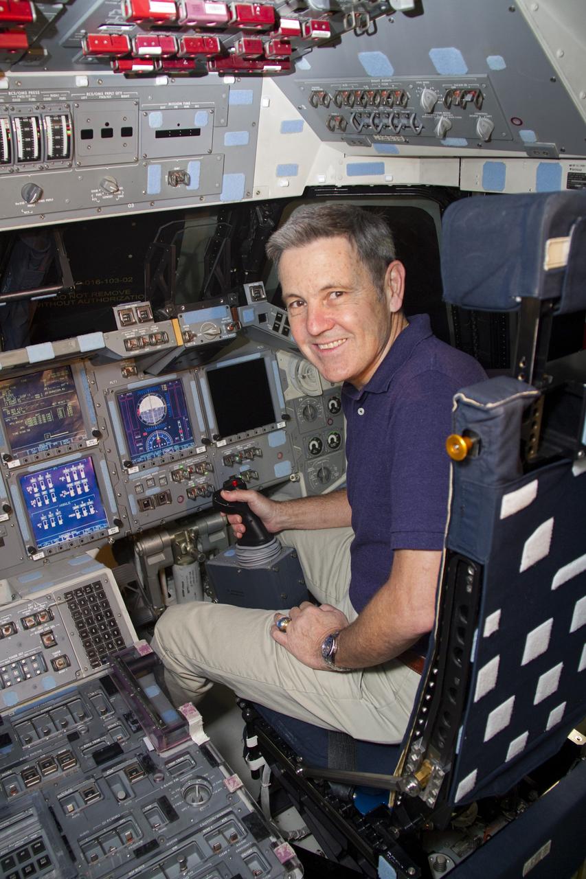 CAPE CANAVERAL, Fla. -- NASA Kennedy Space Center Director Bob Cabana sits at the controls in the flight deck of space shuttle Discovery in Orbiter Processing Facility-1 OPF-1. At the space center in Florida, Cabana is helping John Glenn mark the 50th anniversary of being the first American astronaut to orbit the Earth inside the NASA Mercury Project's Friendship 7 capsule on Feb. 20, 1962. Glenn later returned to space in October 1998 as a payload specialist aboard Discovery's STS-95 mission.     Glenn's launch aboard an Atlas rocket took with it the hopes of an entire nation and ushered in a new era of space travel that eventually led to Americans walking on the moon by the end of the 1960s. Glenn soon was followed into orbit by Scott Carpenter, Walter Schirra and Gordon Cooper. Their fellow Mercury astronauts Alan Shepard and Virgil "Gus" Grissom flew earlier suborbital flights. Deke Slayton, a member of NASA's original Mercury 7 astronauts, was grounded by a medical condition until the Apollo-Soyuz Test Project in 1975. Shuttle Discovery currently is being prepared for display at Smithsonian’s National Air and Space Museum, Steven F. Udvar-Hazy Center in Chantilly, Va. Photo credit: Cory Huston