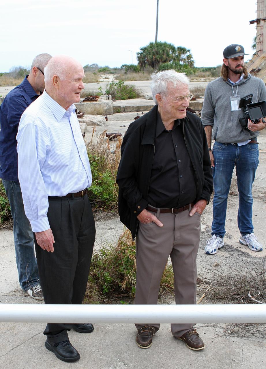 CAPE CANAVERAL, Fla. -- Mercury astronauts John Glenn, second from left and Scott Carpenter look around at the dismantled Complex 14 at Cape Canaveral Air Force Station in Florida. Glenn and Carpenter launched from the pad on Atlas rockets inside Mercury capsules in 1962. The two astronauts, part of the original class of seven astronauts chosen by NASA, were taking part in events celebrating 50 years of Americans in orbit, an era which began with Glenn's Mercury mission MA-6, on Feb. 20, 1962.  Glenn's launch aboard an Atlas rocket took with it the hopes of an entire nation and ushered in a new era of space travel that eventually led to Americans walking on the moon by the end of the 1960s. Glenn soon was followed into orbit by Carpenter, Walter Schirra and Gordon Cooper. Their fellow Mercury astronauts Alan Shepard and Virgil "Gus" Grissom flew earlier suborbital flights. Deke Slayton was grounded by a medical condition until the Apollo-Soyuz Test Project in 1975. Photo credit: NASA/ Cory Huston