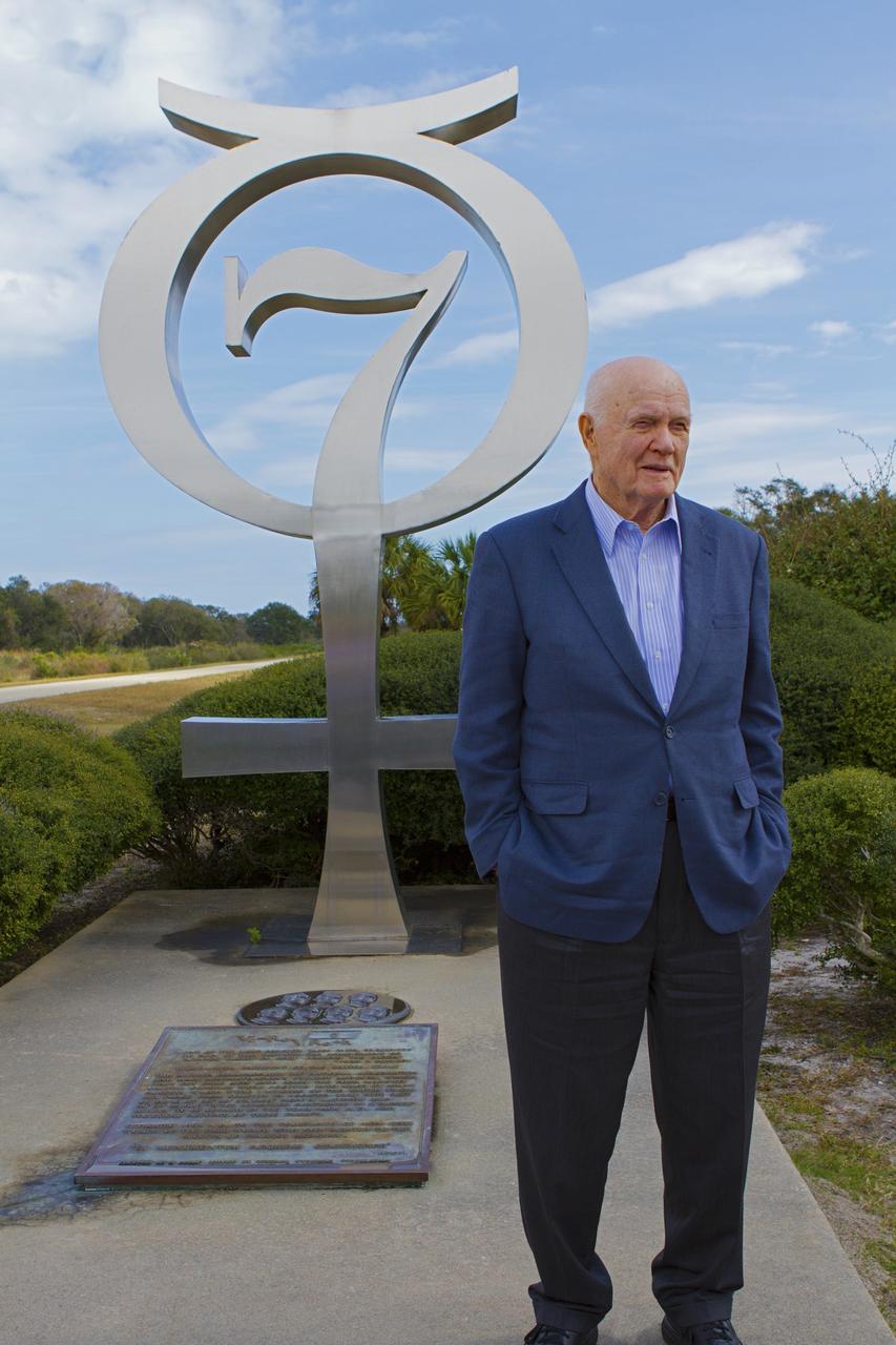 CAPE CANAVERAL, Fla. -- Mercury astronaut John Glenn poses in front of the Mercury 7 memorial near Complex 14 at Cape Canaveral Air Force Station in Florida. Glenn and Carpenter launched from the pad on Atlas rockets inside Mercury capsules in 1962. The two astronauts, part of the original class of seven astronauts chosen by NASA, were taking part in events celebrating 50 years of Americans in orbit, an era which began with Glenn's Mercury mission MA-6, on Feb. 20, 1962.  Glenn's launch aboard an Atlas rocket took with it the hopes of an entire nation and ushered in a new era of space travel that eventually led to Americans walking on the moon by the end of the 1960s. Glenn soon was followed into orbit by Carpenter, Walter Schirra and Gordon Cooper. Their fellow Mercury astronauts Alan Shepard and Virgil "Gus" Grissom flew earlier suborbital flights. Deke Slayton was grounded by a medical condition until the Apollo-Soyuz Test Project in 1975. Photo credit: NASA/ Cory Huston