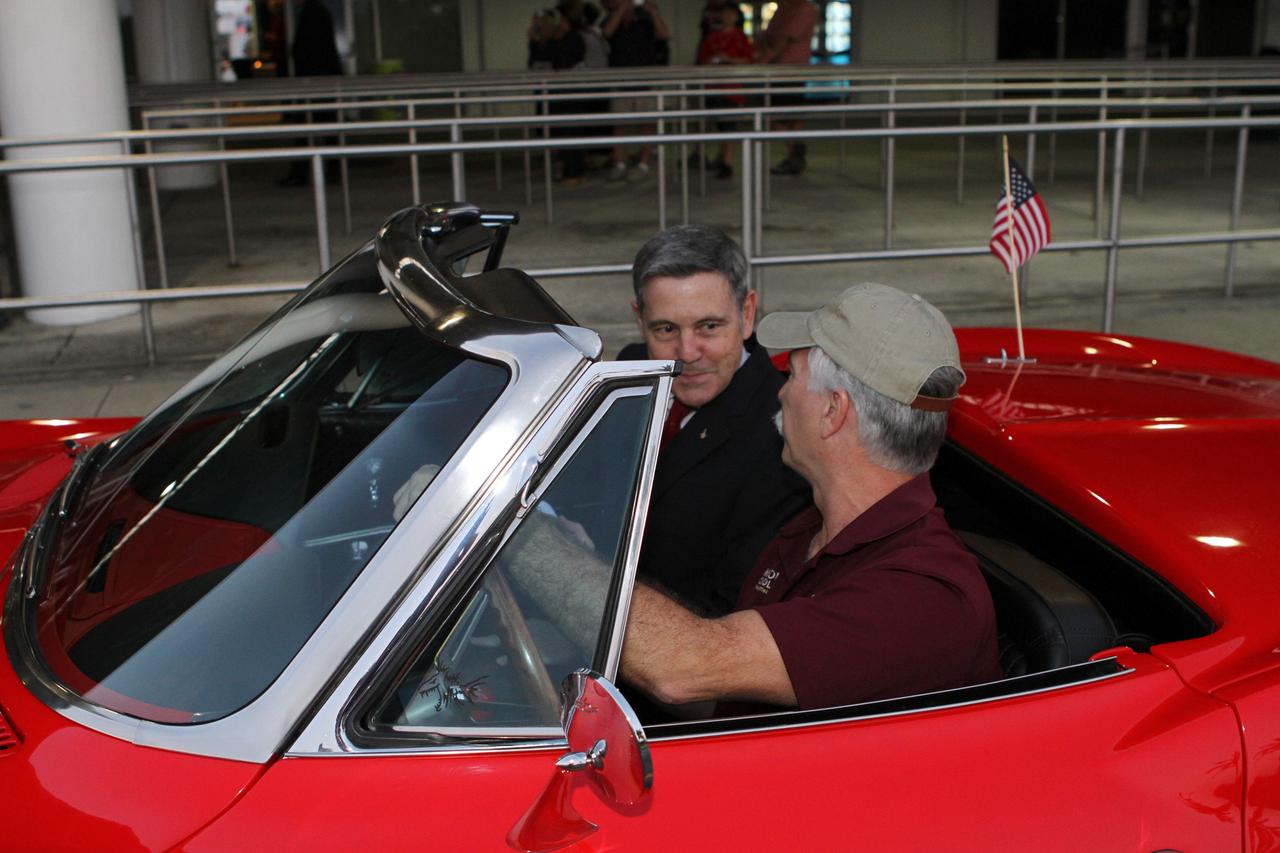 CAPE CANAVERAL, Fla. --Kennedy Space Center Director Bob Cabana, left, prepares to ride in the Corvette parade following the "On Shoulders of Giants" program celebrating 50 years of Americans in orbit, an era which began with Glenn's MA-6 mission on Feb. 20, 1962. The event was conducted in the Rocket Garden at the Kennedy Space Center Visitor Complex in Florida a few miles from the launch pad where Glenn and Scott Carpenter took flight in Mercury spacecraft.  Glenn's launch aboard an Atlas rocket took with it the hopes of an entire nation and ushered in a new era of space travel that eventually led to Americans walking on the moon by the end of the 1960s. Glenn soon was followed into orbit by Scott Carpenter, Walter Schirra and Gordon Cooper. Their fellow Mercury astronauts Alan Shepard and Virgil "Gus" Grissom flew earlier suborbital flights. Deke Slayton, a member of NASA's original Mercury 7 astronauts, was grounded by a medical condition until the Apollo-Soyuz Test Project in 1975. Photo credit: Kim Shiflett