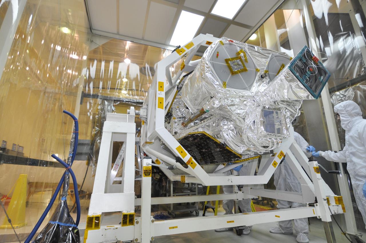 VANDENBERG AIR FORCE BASE, Calif. – Inside an environmental enclosure at Vandenberg Air Force Base's processing facility in California, NASA's Nuclear Spectroscopic Telescope Array, or NuSTAR, secured inside a turnover rotation fixture, moves toward interface with its Orbital Sciences Pegasus XL rocket.  The uniting of the spacecraft with the rocket is a major milestone in prelaunch preparations.      After processing of the rocket and spacecraft are complete, they will be flown on Orbital's L-1011 carrier aircraft from Vandenberg to the Ronald Reagan Ballistic Missile Defense Test Site on the Pacific Ocean’s Kwajalein Atoll for launch. The high-energy x-ray telescope will conduct a census of black holes, map radioactive material in young supernovae remnants, and study the origins of cosmic rays and the extreme physics around collapsed stars. For more information, visit http://www.nasa.gov/nustar.  Photo credit: NASA/Randy Beaudoin, VAFB