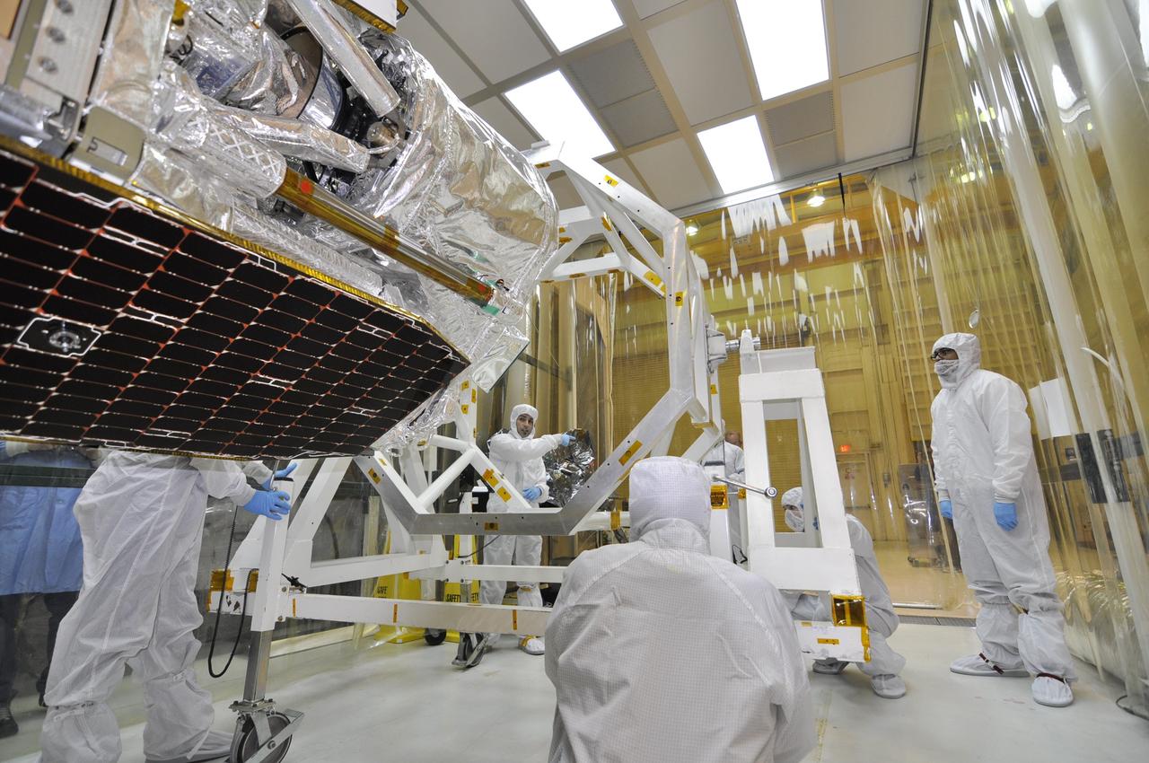 VANDENBERG AIR FORCE BASE, Calif. – Inside an environmental enclosure at Vandenberg Air Force Base's processing facility in California, the solar panels on NASA's Nuclear Spectroscopic Telescope Array, or NuSTAR, are in view after the removal of the turnover rotation fixture from around the spacecraft. The fixture was used to rotate the spacecraft into a horizontal position and supported it during its mating to an Orbital Sciences Pegasus XL rocket. The uniting of the spacecraft with the rocket is a major milestone in prelaunch preparations. After processing of the rocket and spacecraft are complete, they will be flown on Orbital's L-1011 carrier aircraft from Vandenberg to the Ronald Reagan Ballistic Missile Defense Test Site on the Pacific Ocean’s Kwajalein Atoll for launch. The high-energy x-ray telescope will conduct a census of black holes, map radioactive material in young supernovae remnants, and study the origins of cosmic rays and the extreme physics around collapsed stars. For more information, visit http://www.nasa.gov/nustar. Photo credit: NASA/Randy Beaudoin, VAFB
